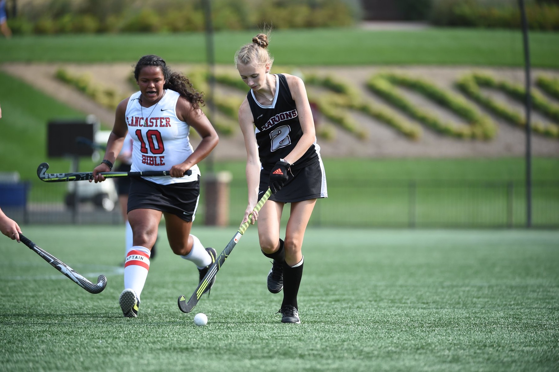 action picture of Emilee Wooten carrying the ball past a defender 