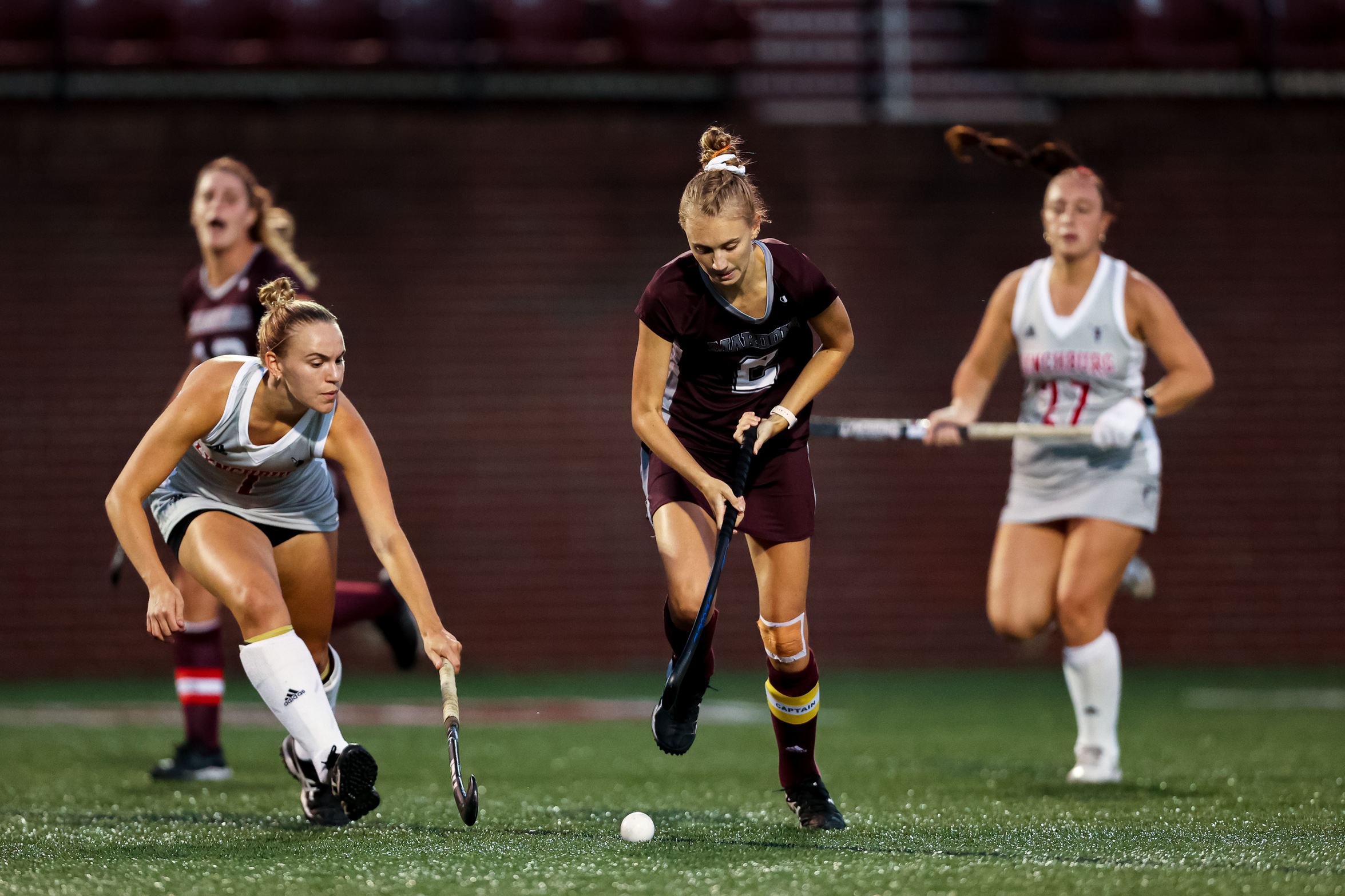 action photo of RC field hockey player Emilee Wooten dribbling past defenders