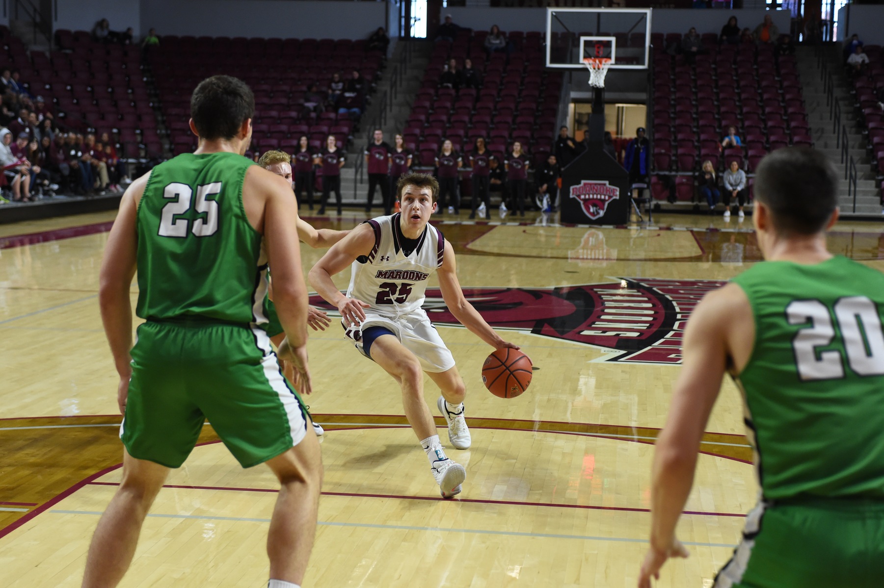 action photo of RC basketball player Joe Mikalauskas dribbling into the lane