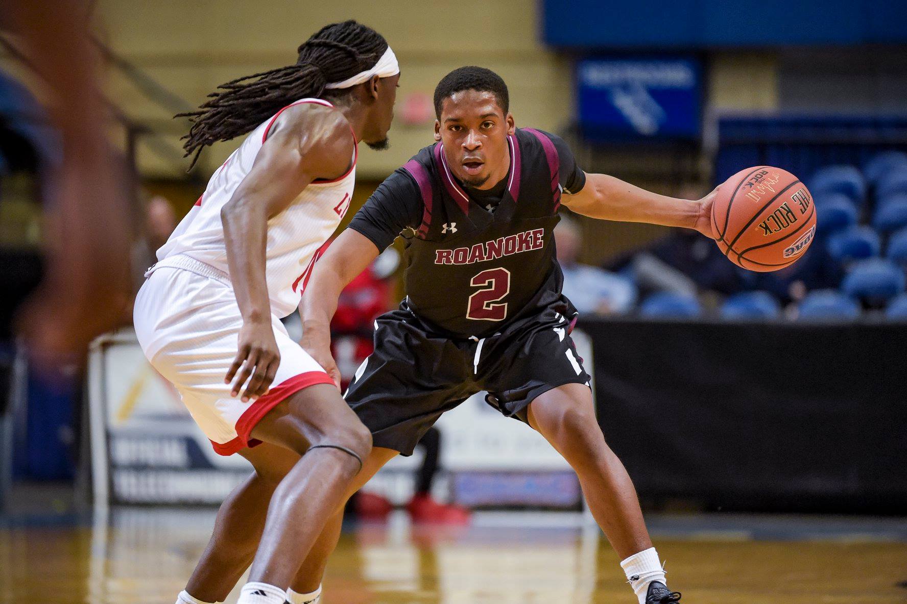 action photo of RC basketball player Caleb Jordan dribbling 