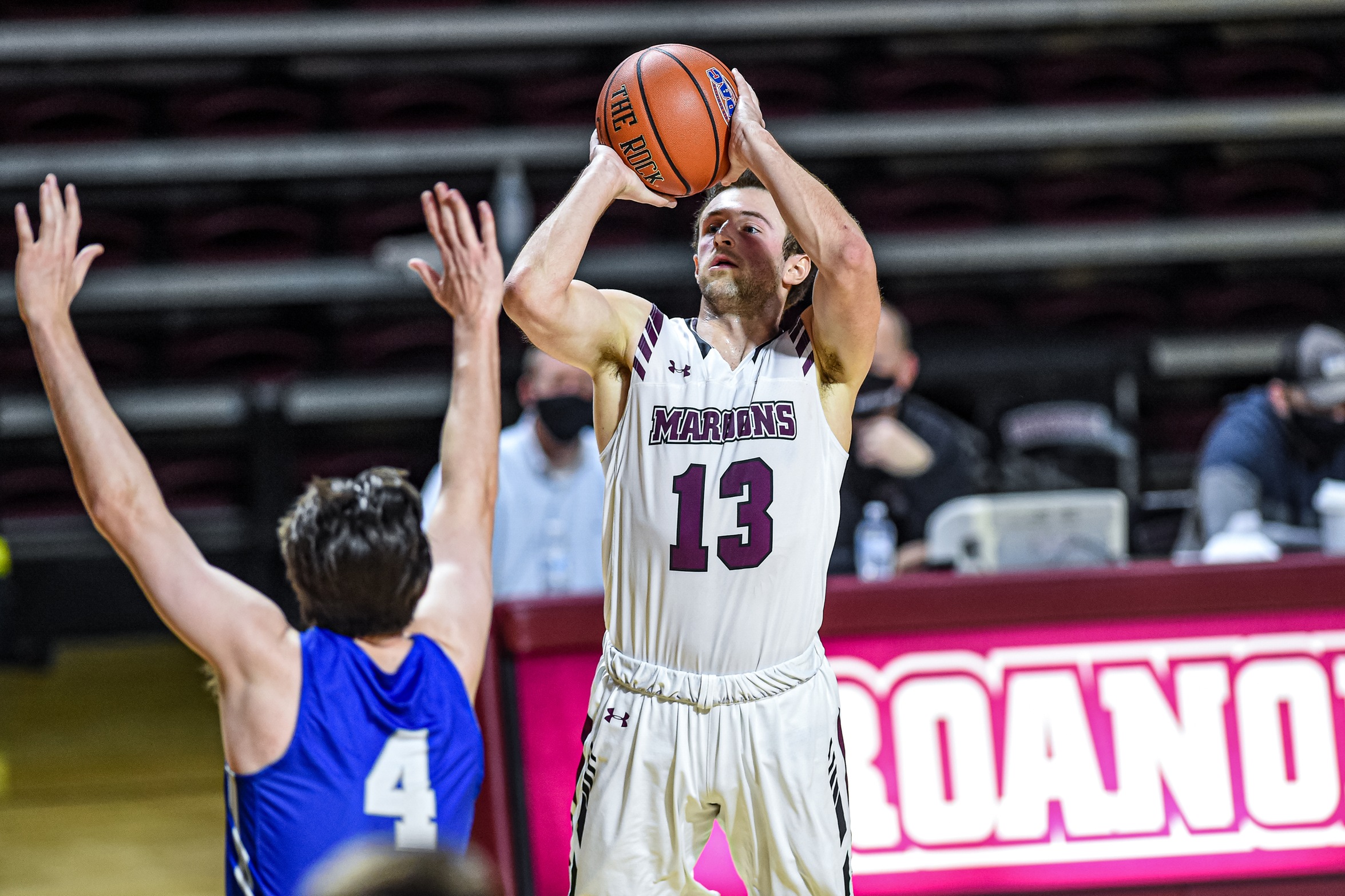 action shot of RC basketball player Tripp Greene shooting a jump shot