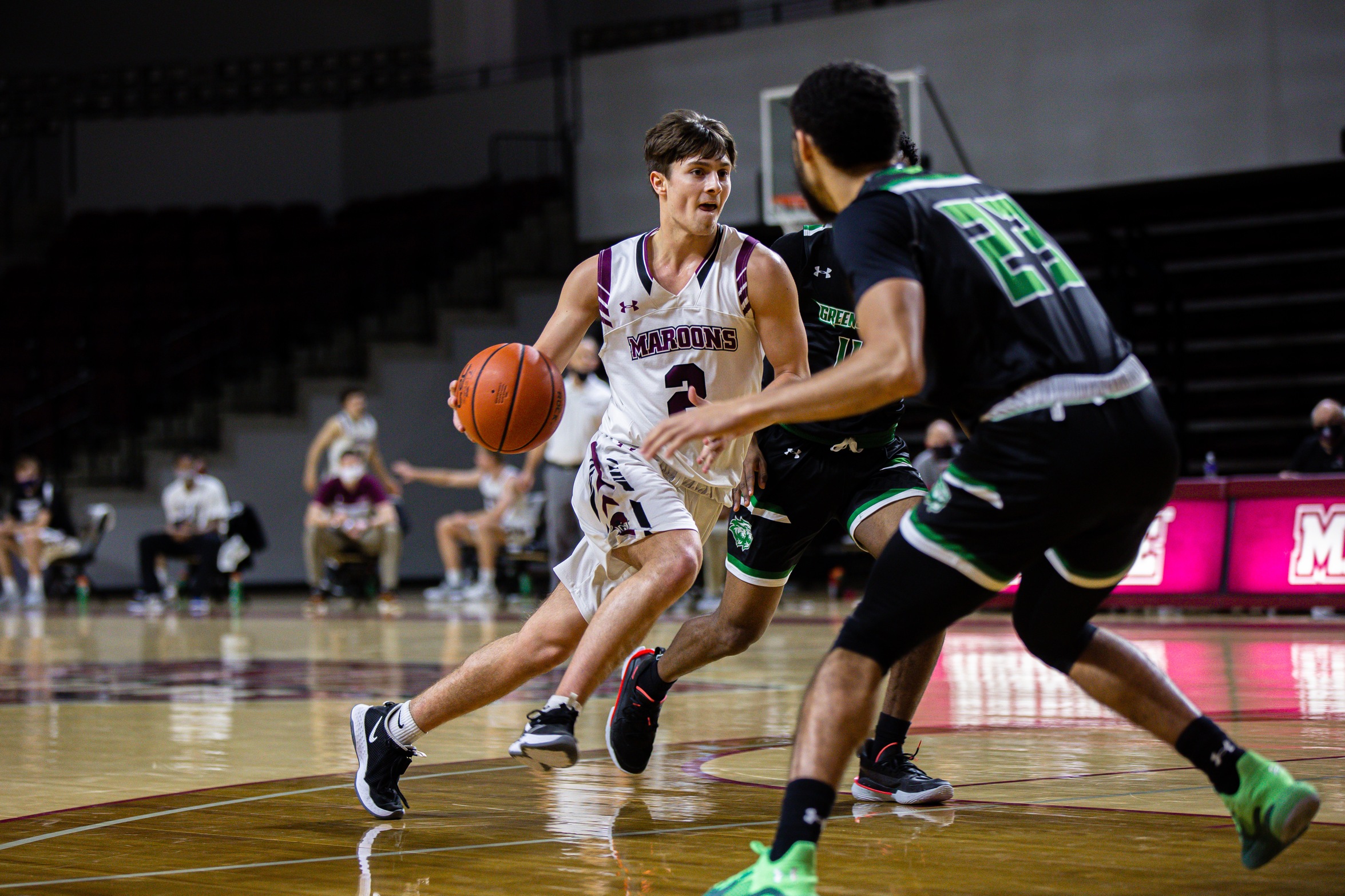action photo of RC basketball player Trent Dawson driving past a defender