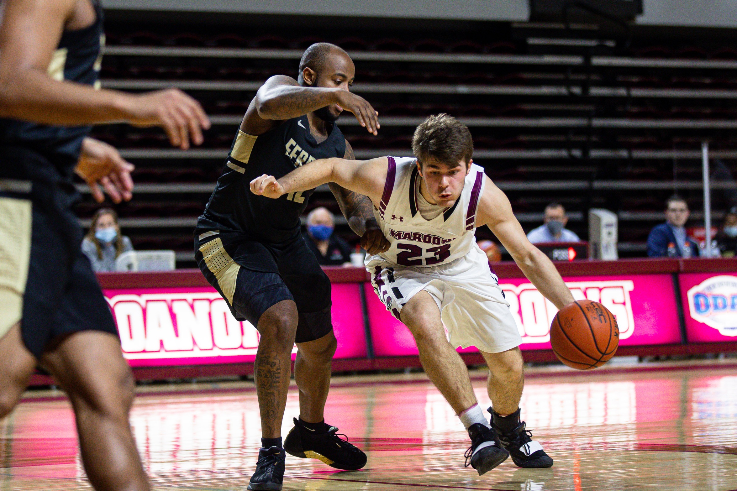 action photo of RC basketball player Kasey Draper driving to the basket