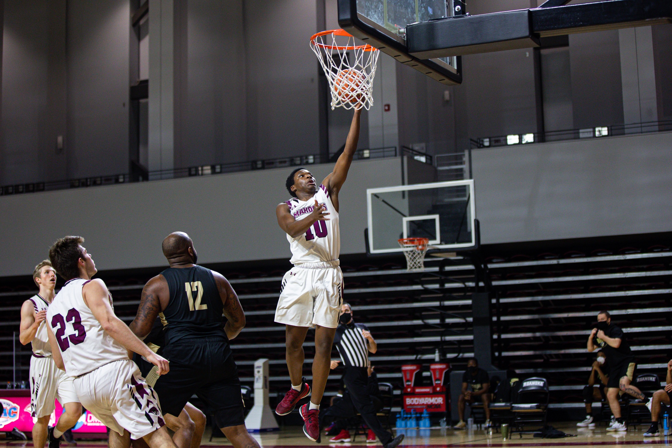 action photo of RC basketball player Efosa Edosomwan laying in the ball 
