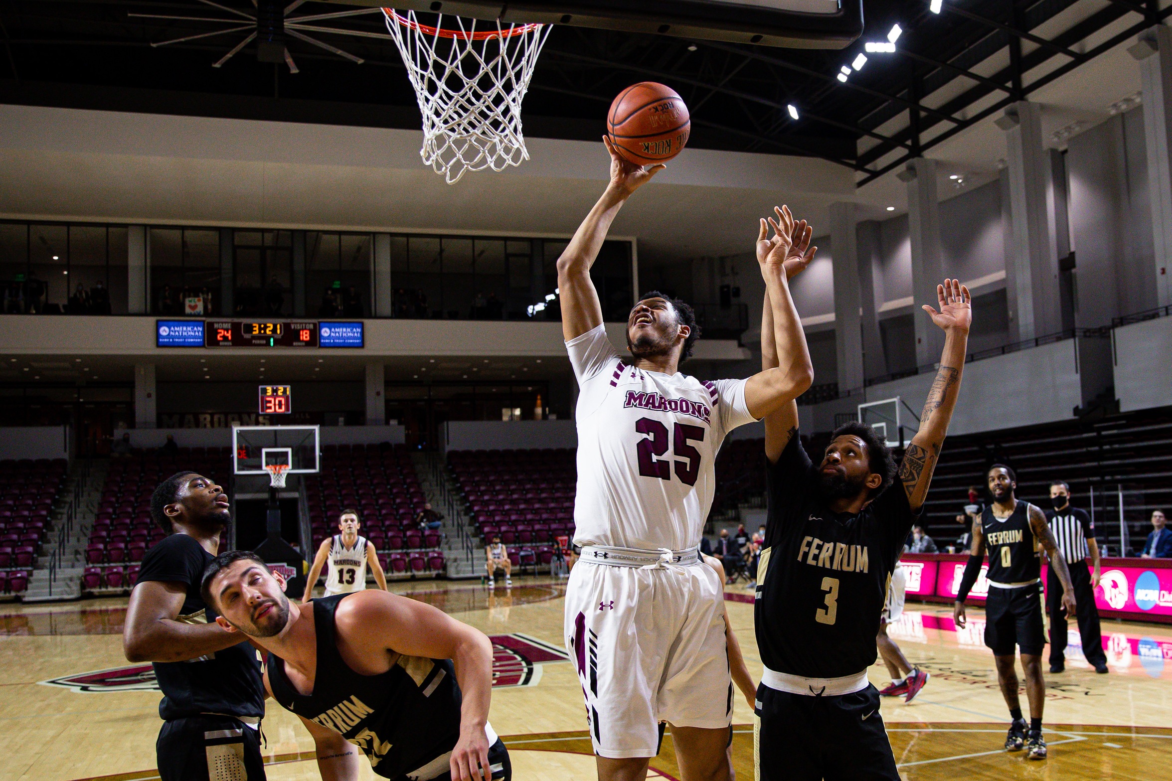 action shot of RC basketball player Ethan Rohan grabbing a rebound