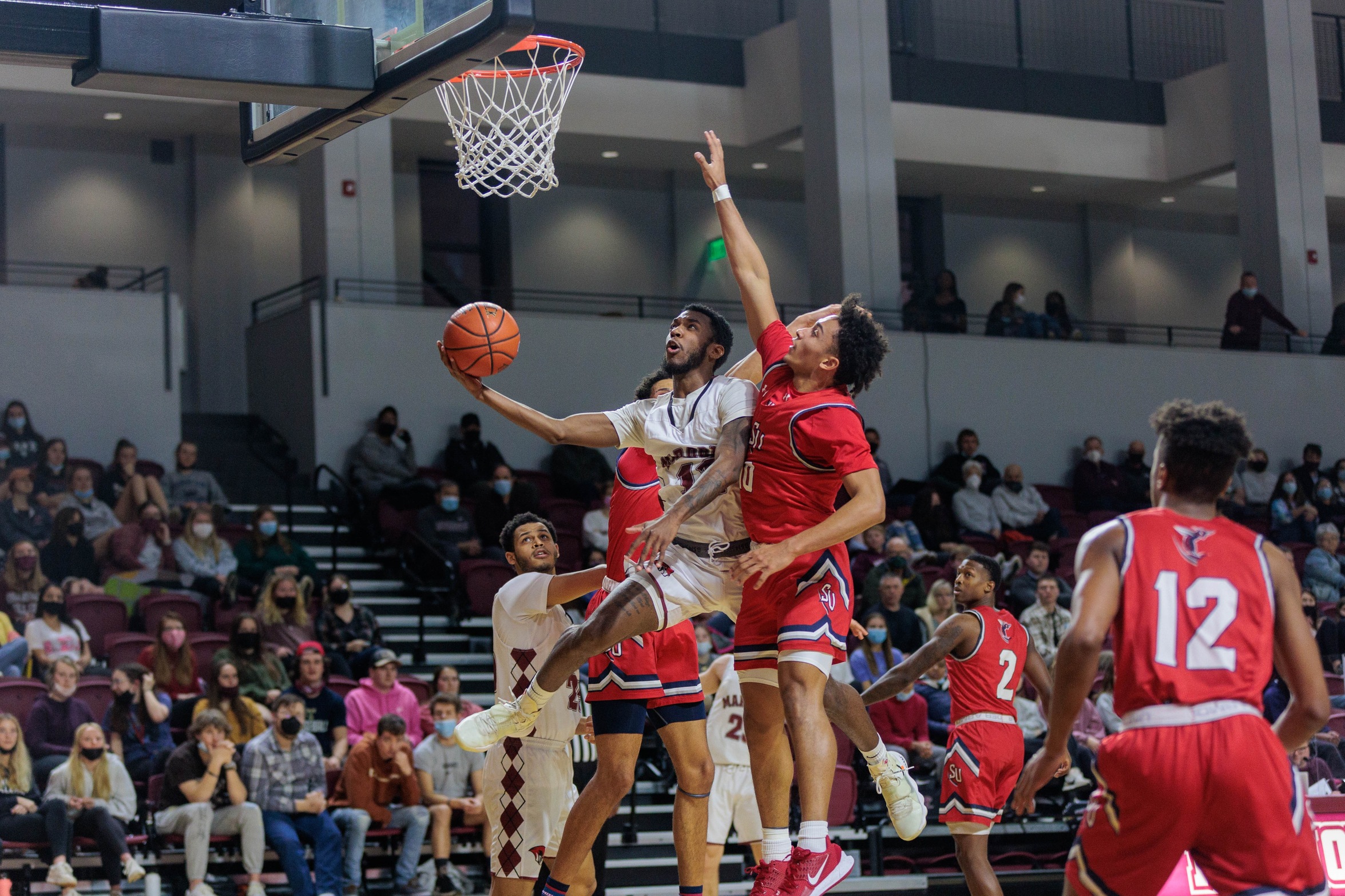action photo of RC MBB Nick Price scoring against a defender