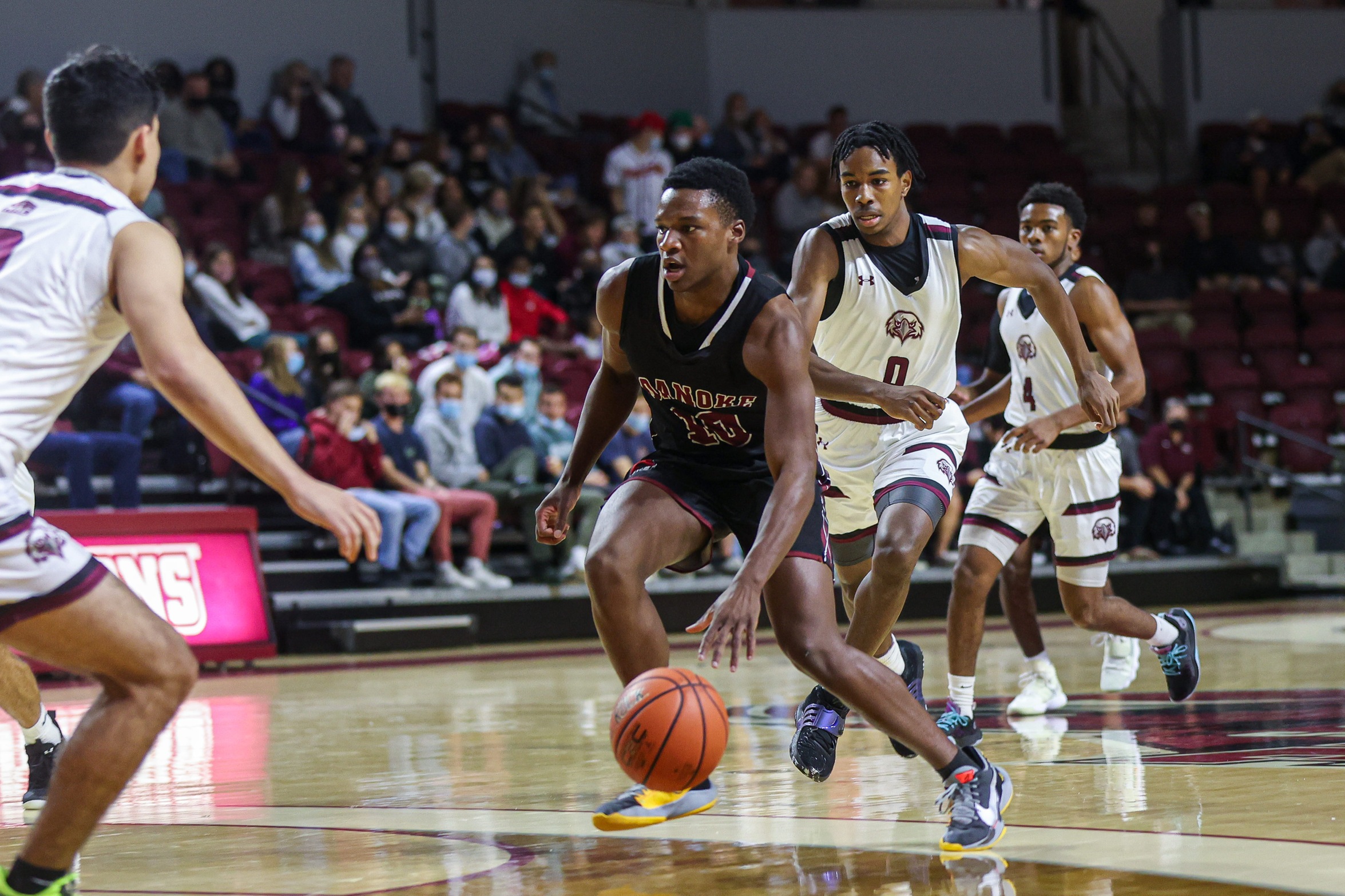 action photo of RC men's basketball player Efosa U-Edosomwan driving to the lane
