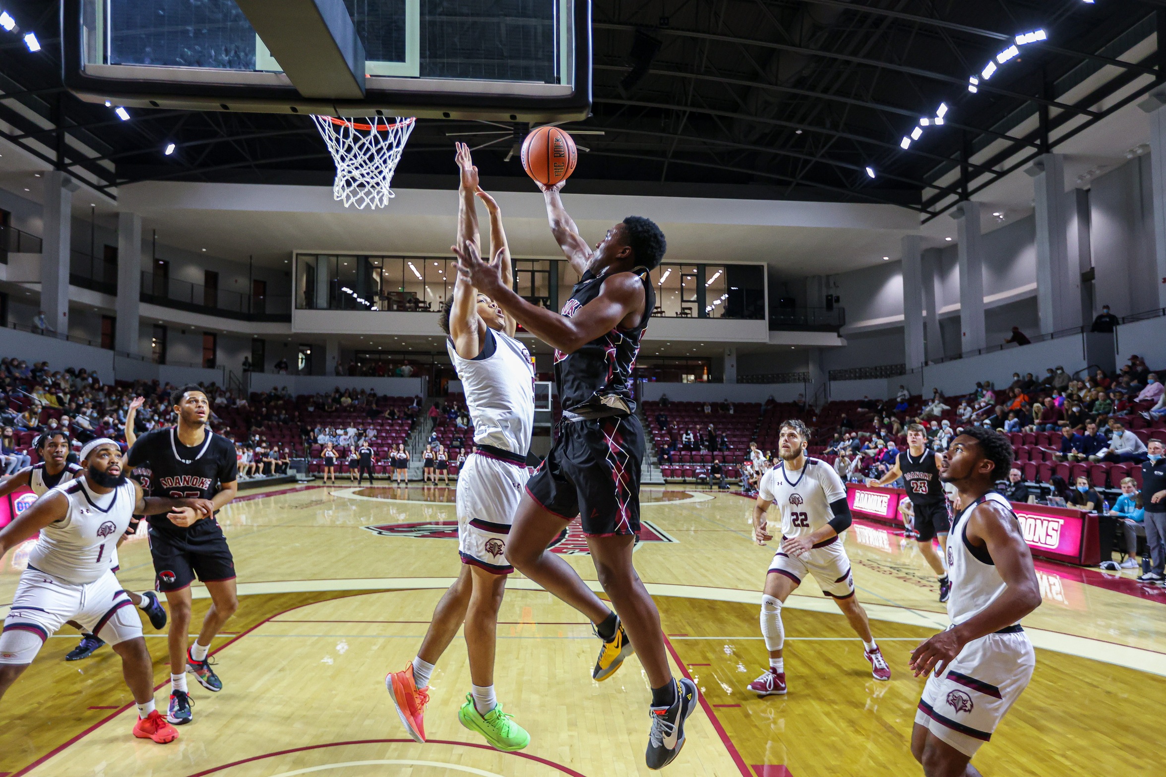 action photo of RC men's basketball player Efosa U-Edosomwan scoring at the rim