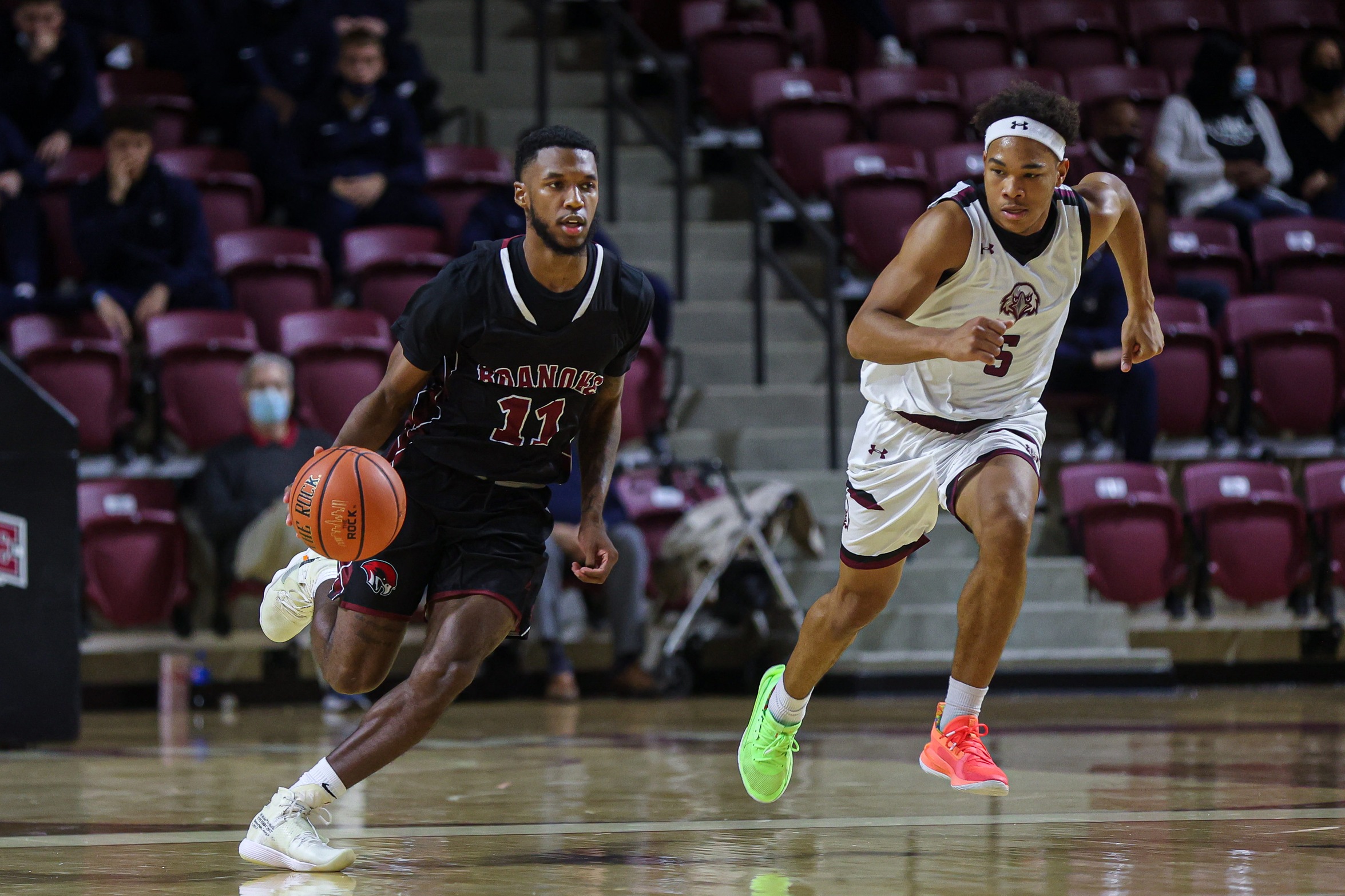 action photo of RC point guard Nick Price dribbling past a defender