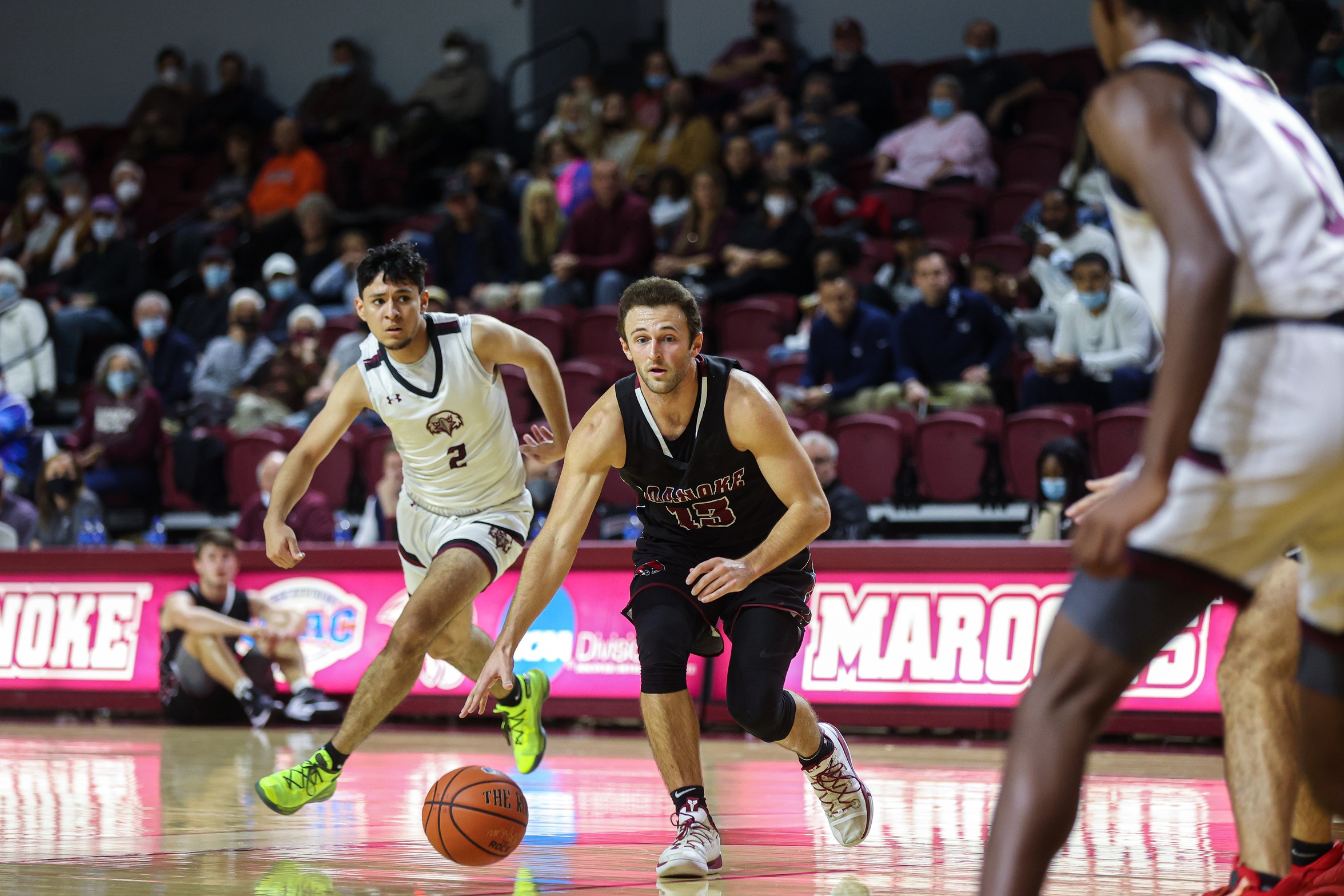 action photo of RC men's basketball Tripp Greene dribbling into the lane