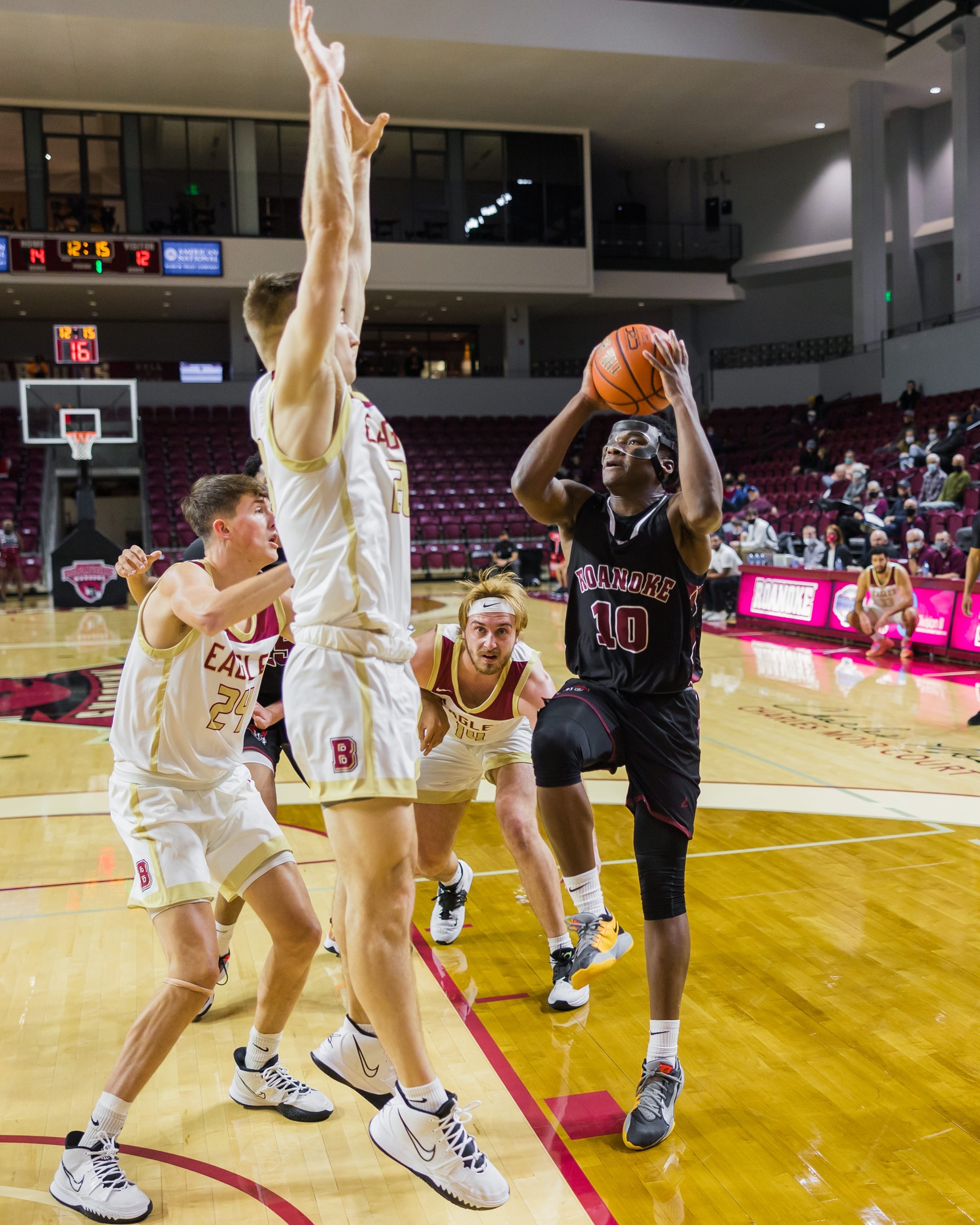action photo of RC basketball player Efosa U-Edosomwan going against a defender