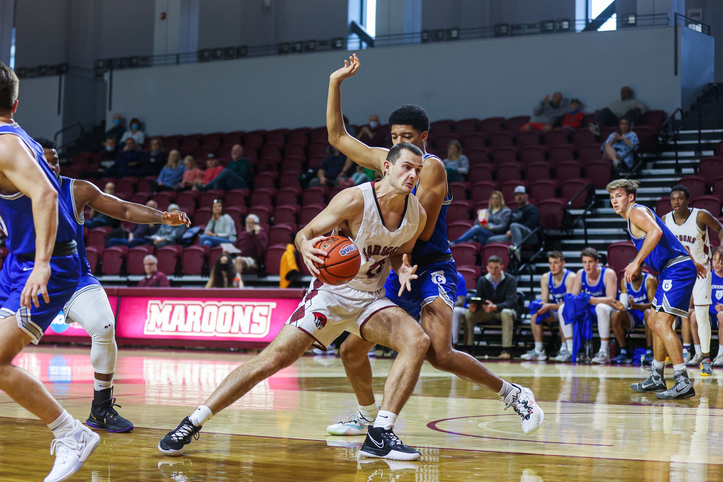action photo of RC men's basketball player Justin Kuthan going to the hoop