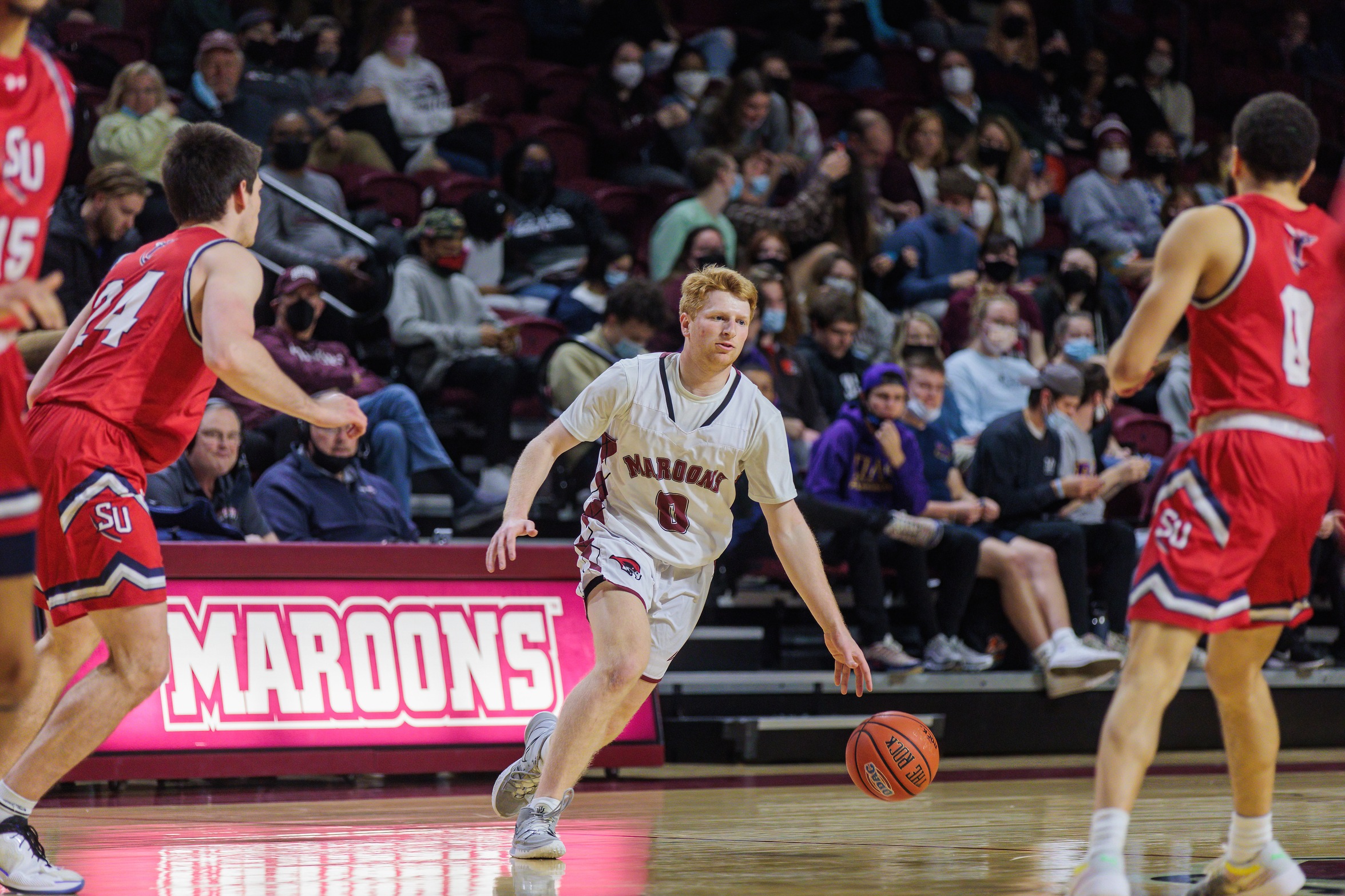 action photo of RC basketball player Zach Rosenthal dribbling into the front court