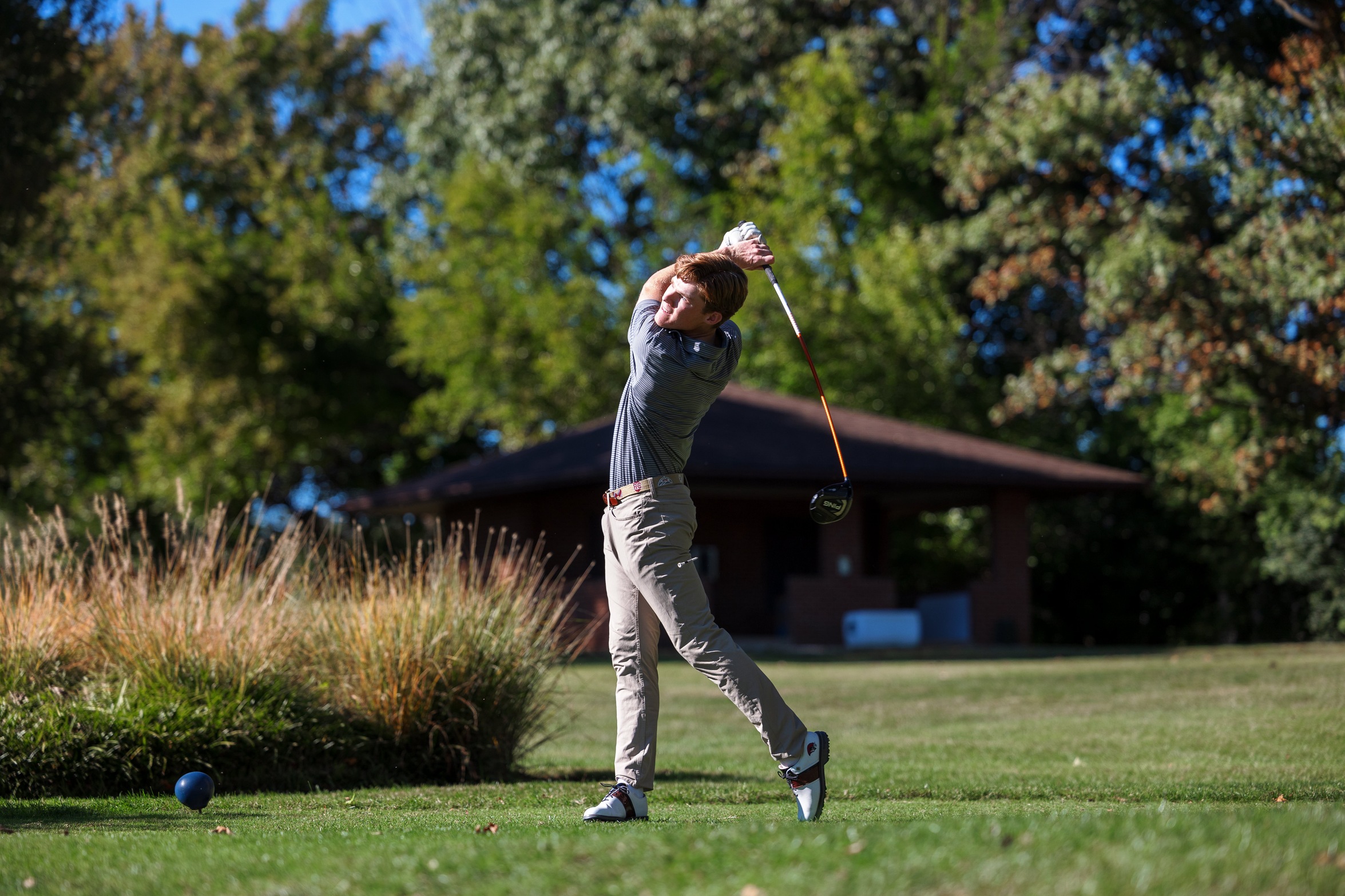 action photo of golfer Palmer Cuny teeing off