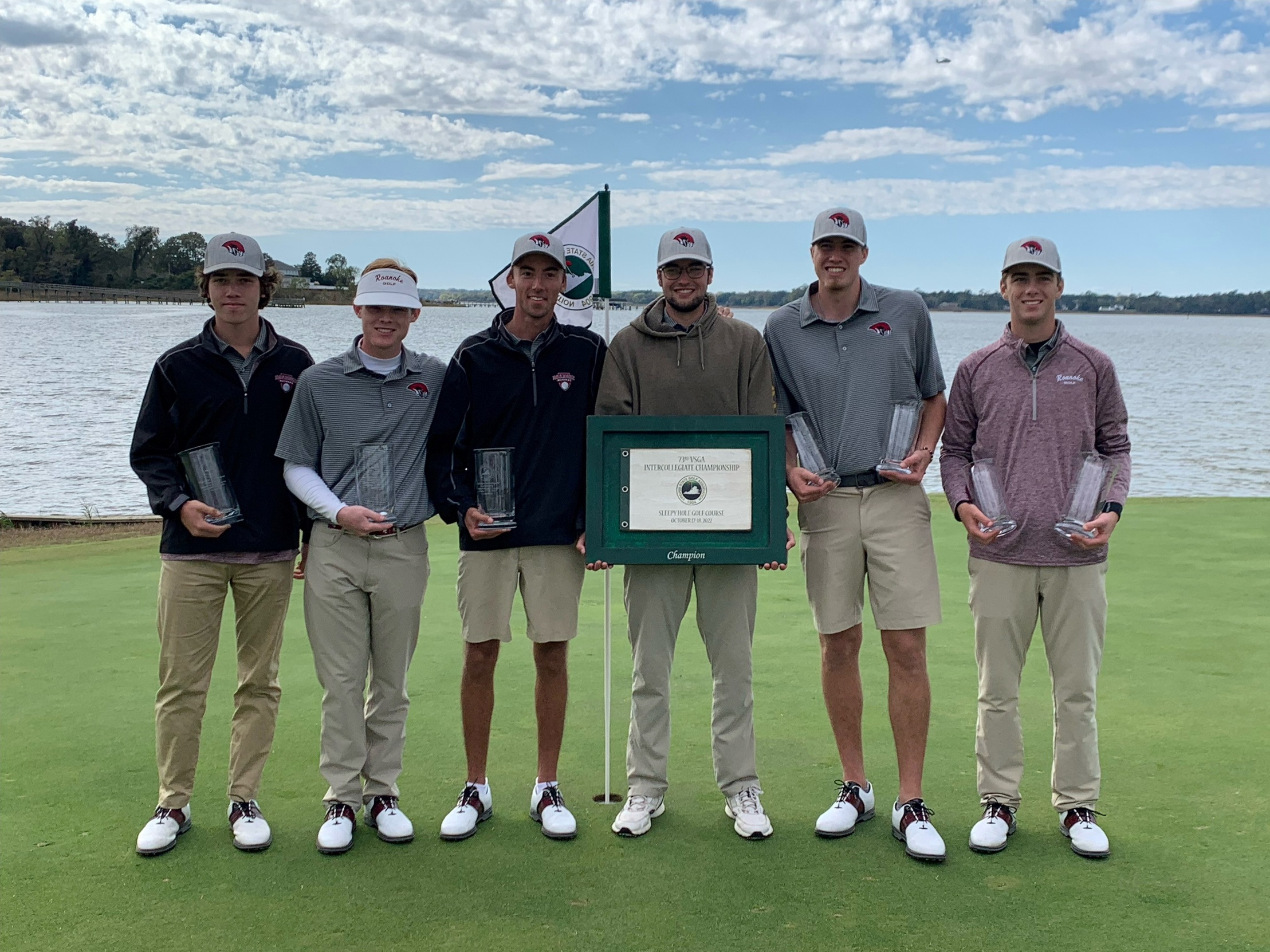 posed shot of six RC golfers with trophies and the championship plaque. 
