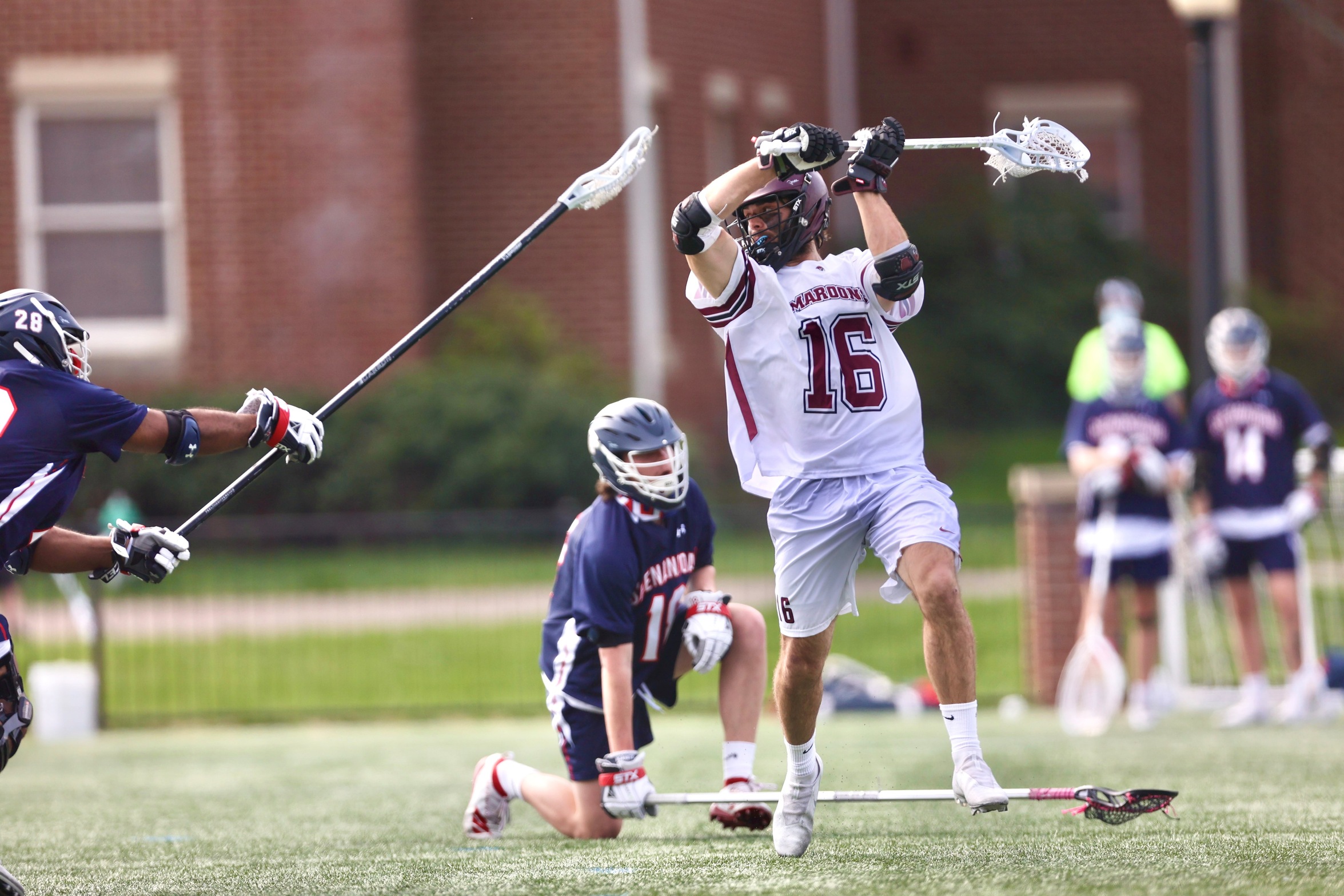 action photo of RC lacrosse player George Gilbert taking a shot 