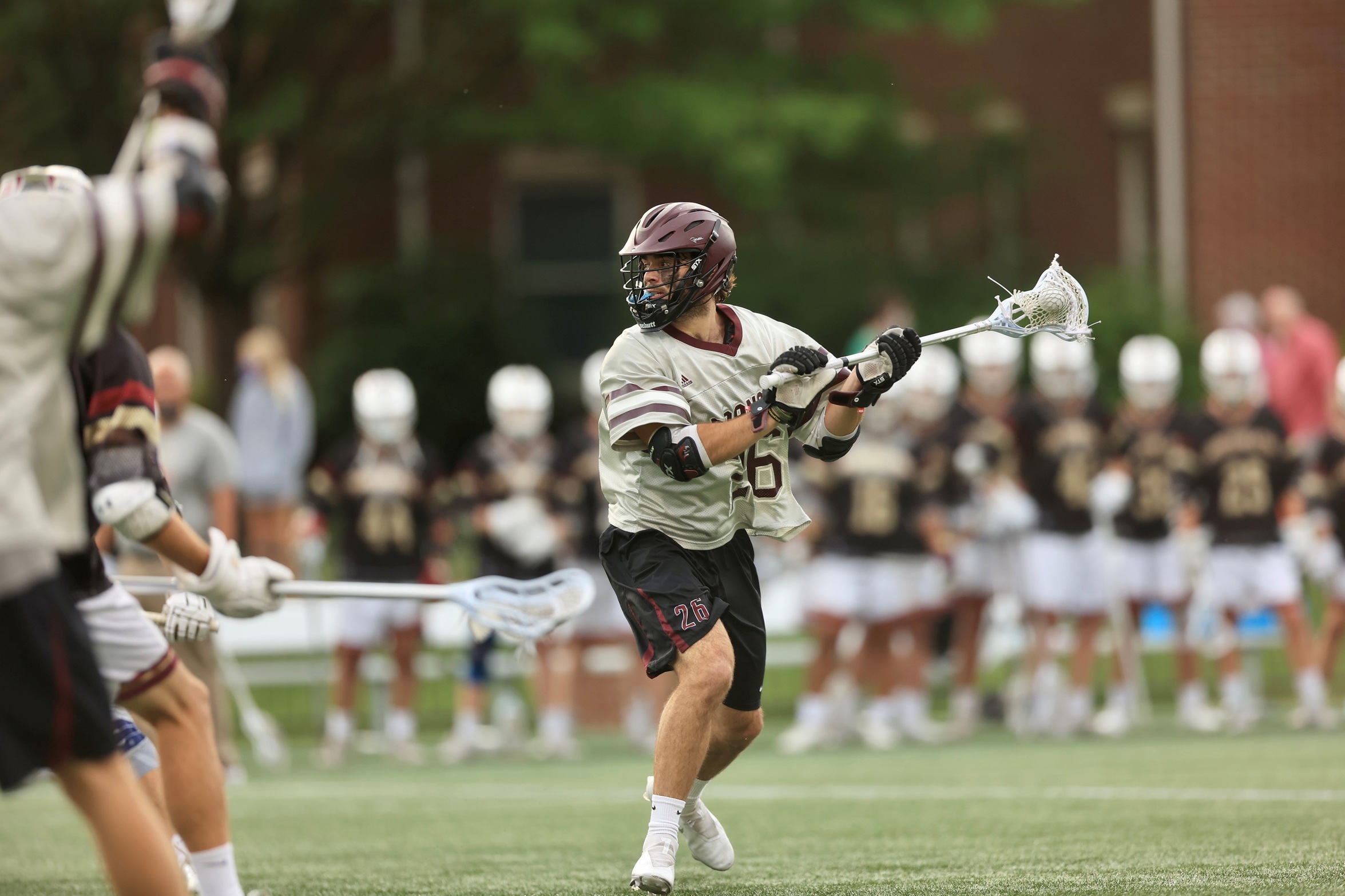 action photo of RC lacrosse player George Gilbert gearing up for a shot