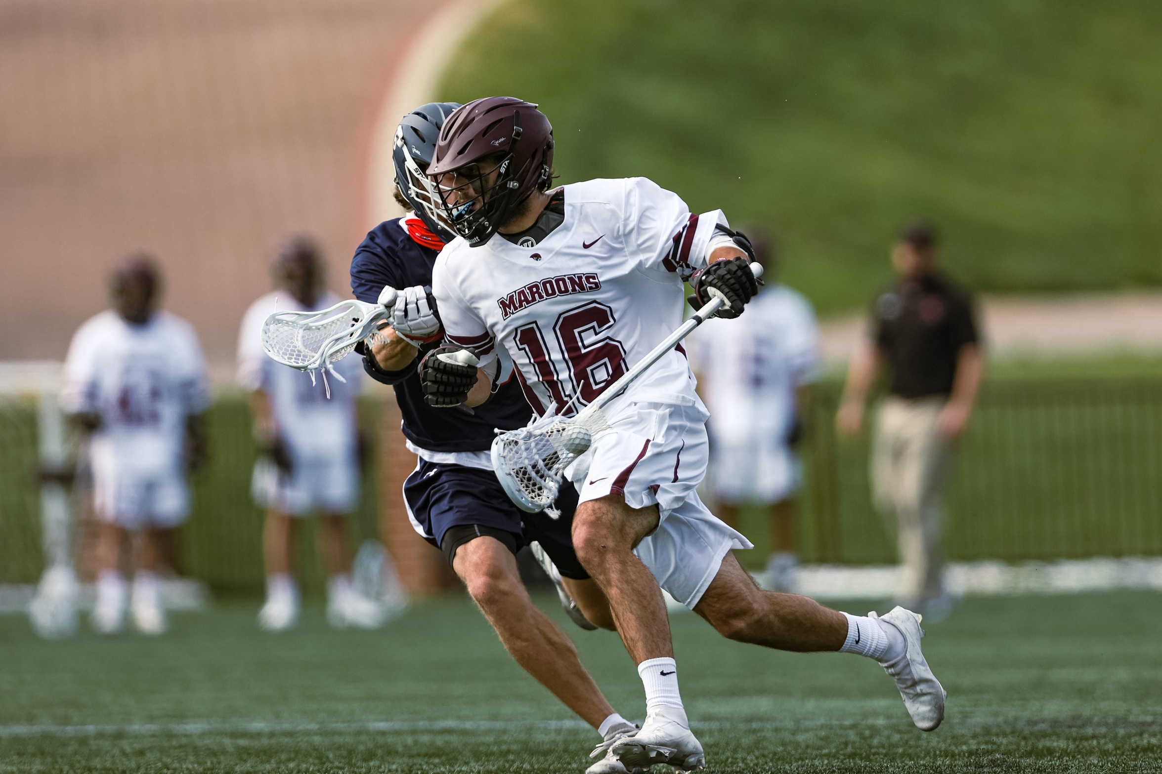 action photo of RC lacrosse player George Gilbert going past a defender