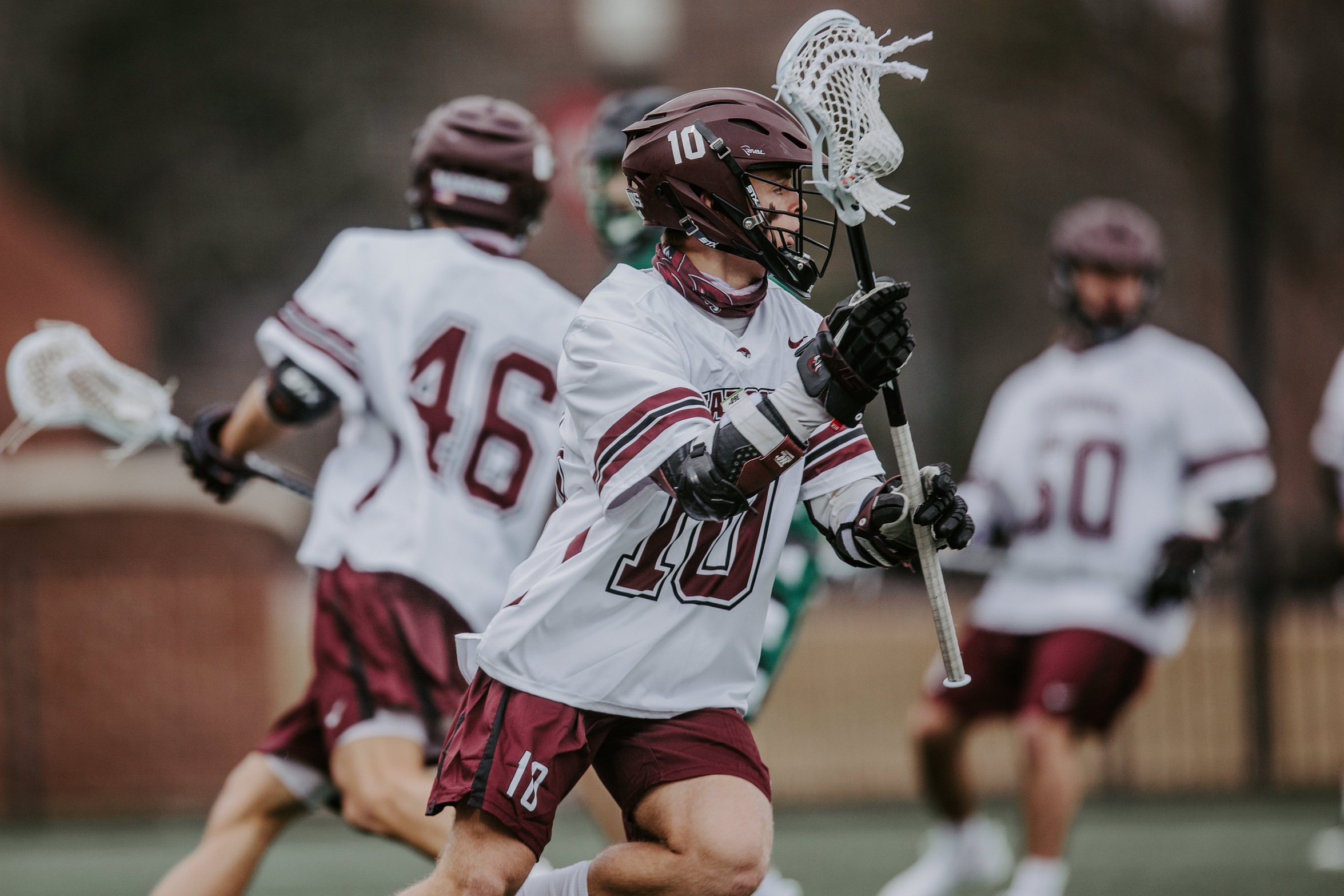 action photo of RC men's lax Sean Kennedy with the ball
