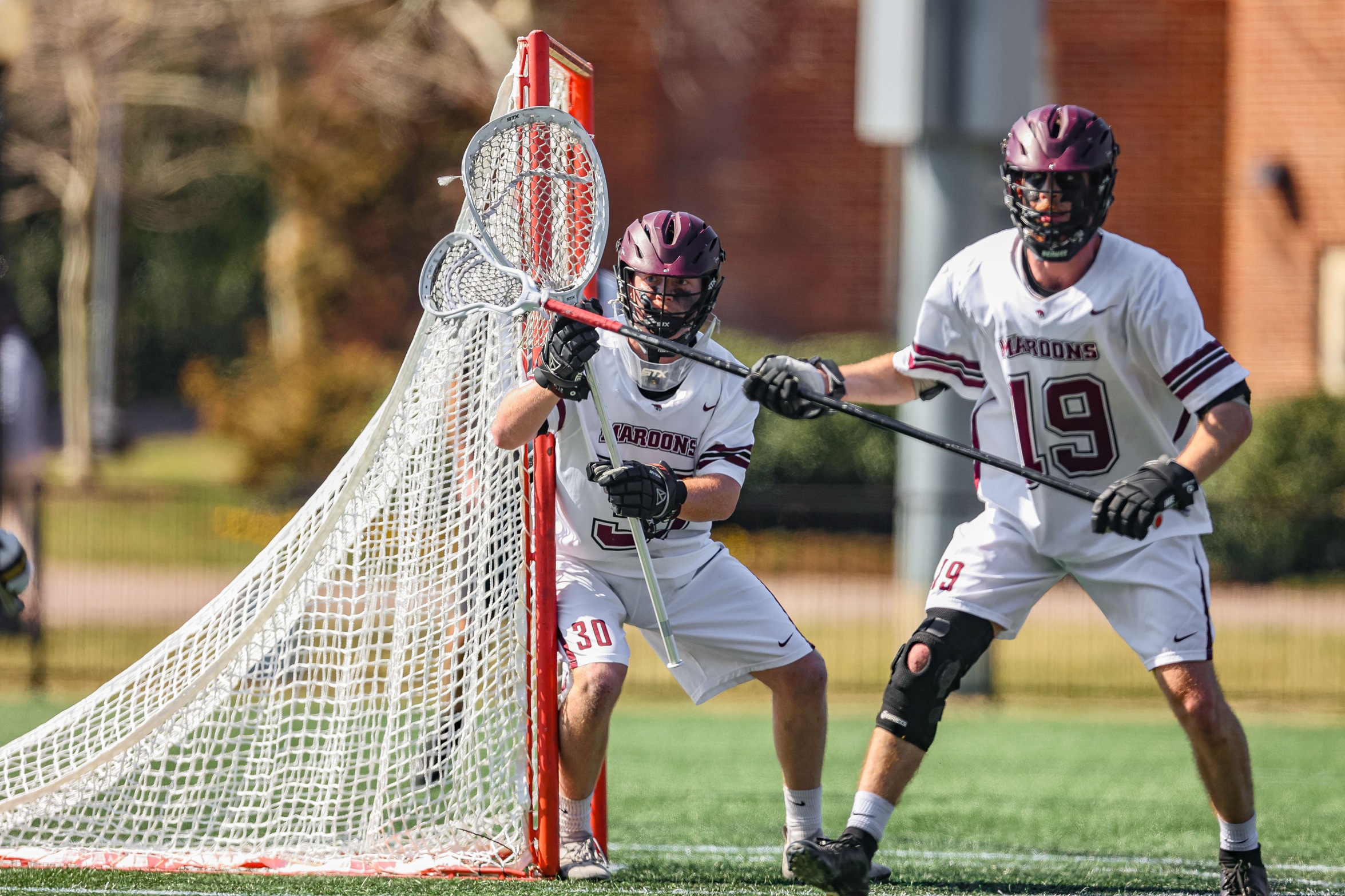 action photo of Roanoke lacrosse goalie and defenseman awaiting the opposition 