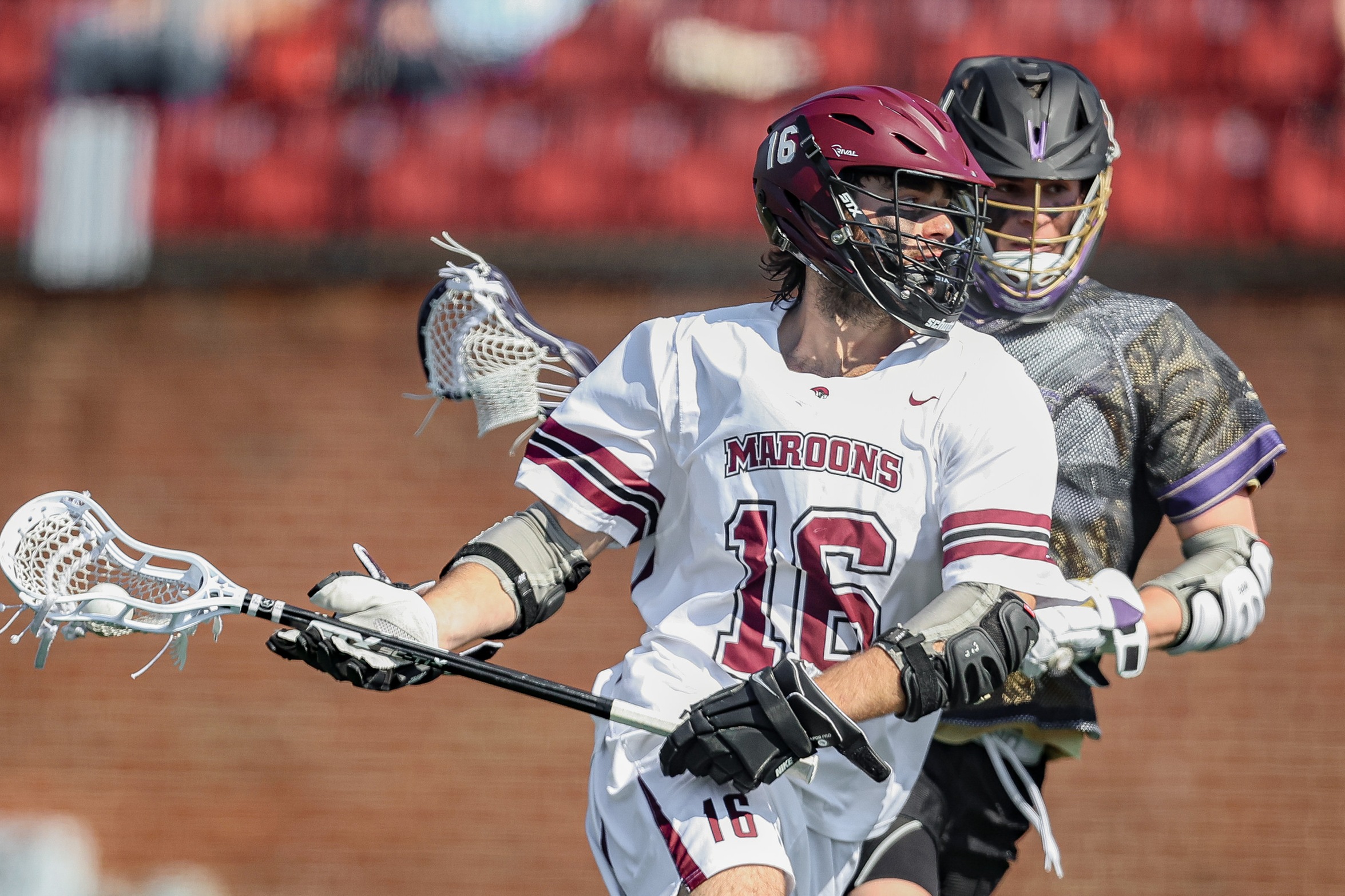 action photo of RC men's lax player George Gilbert with a defender on his back