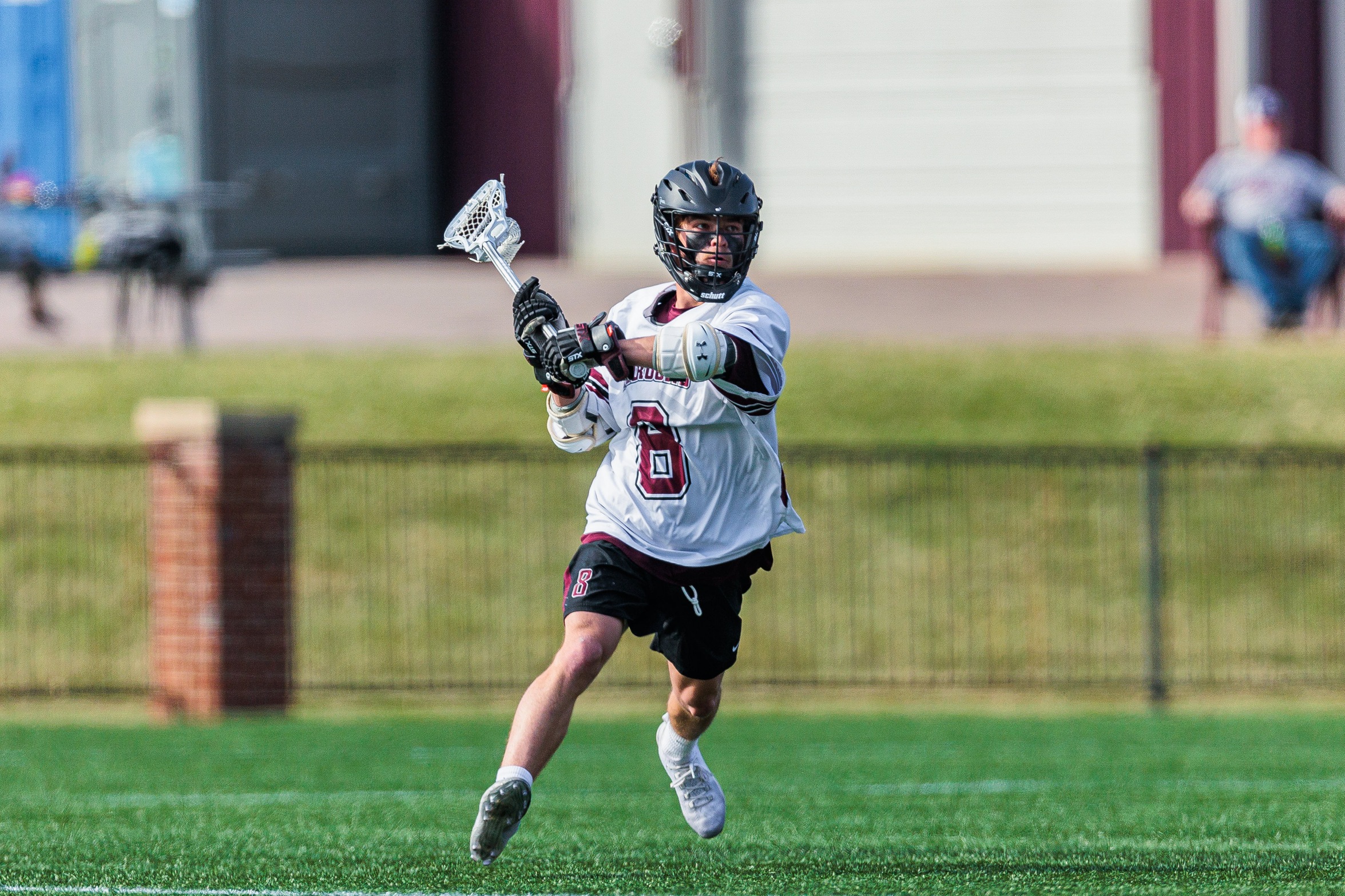 action phot of RC men's lacrosse midfielder Quinn Evans