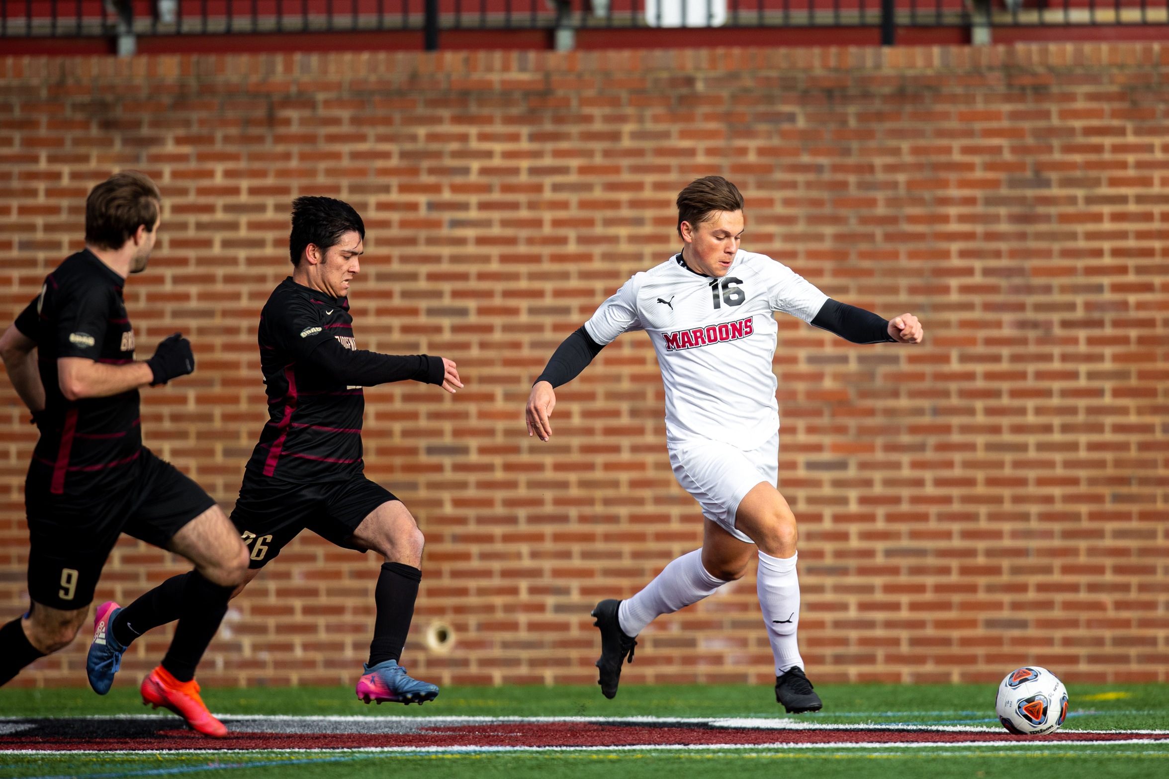 action photo of RC soccer player Chris Jerrild going after a ball