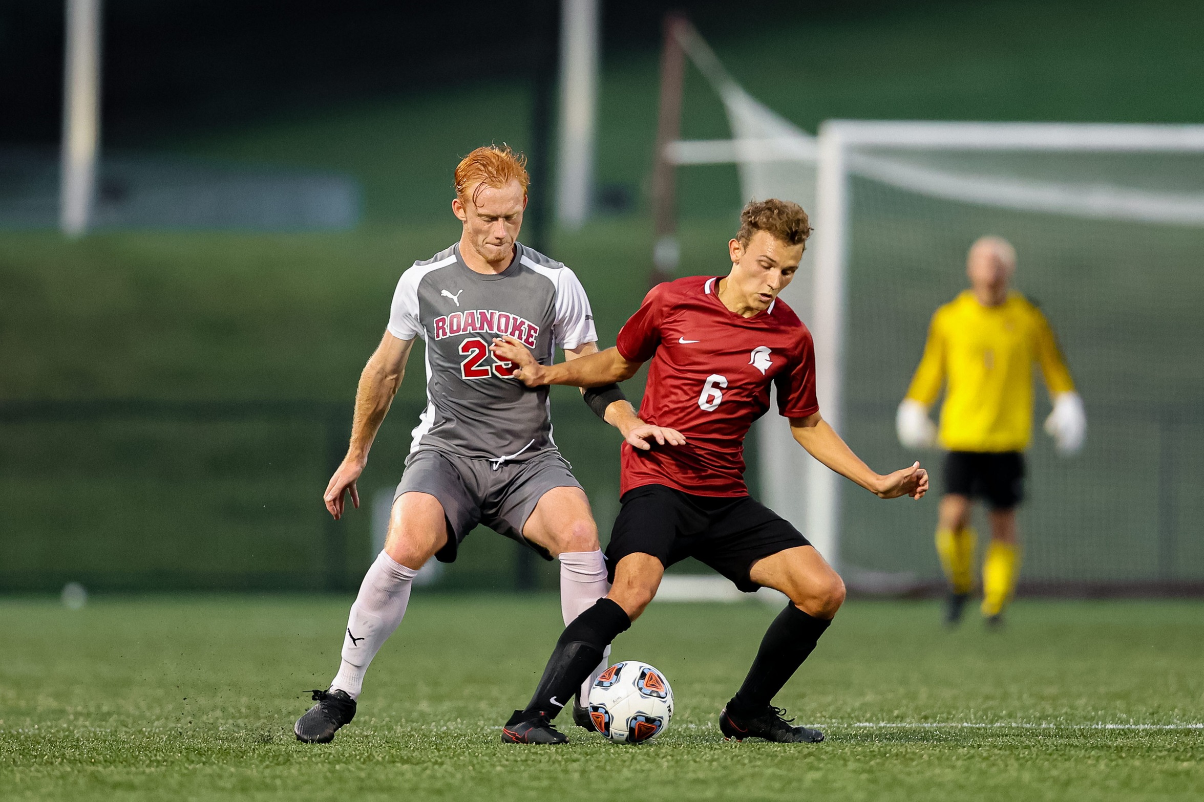 action photo of RC men's soccer defender Joe Carman battling for a ball