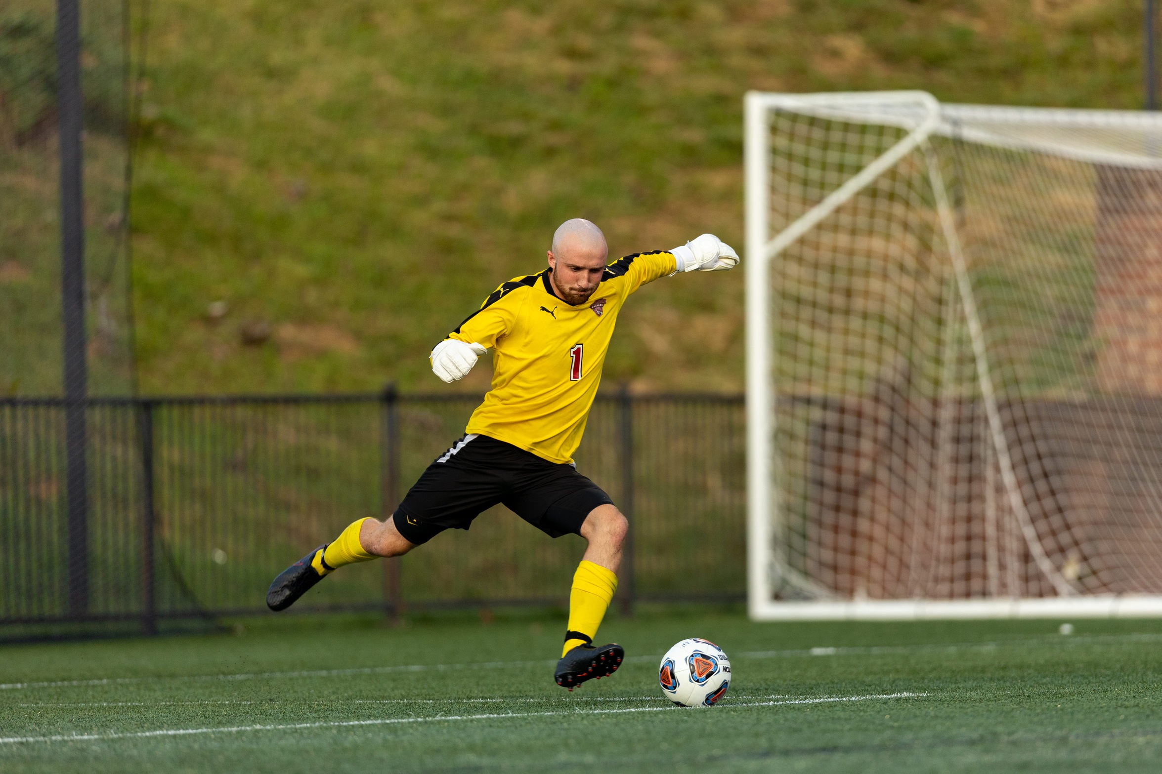 action photo of RC soccer goalkeeper Zach Behe with a goal kick