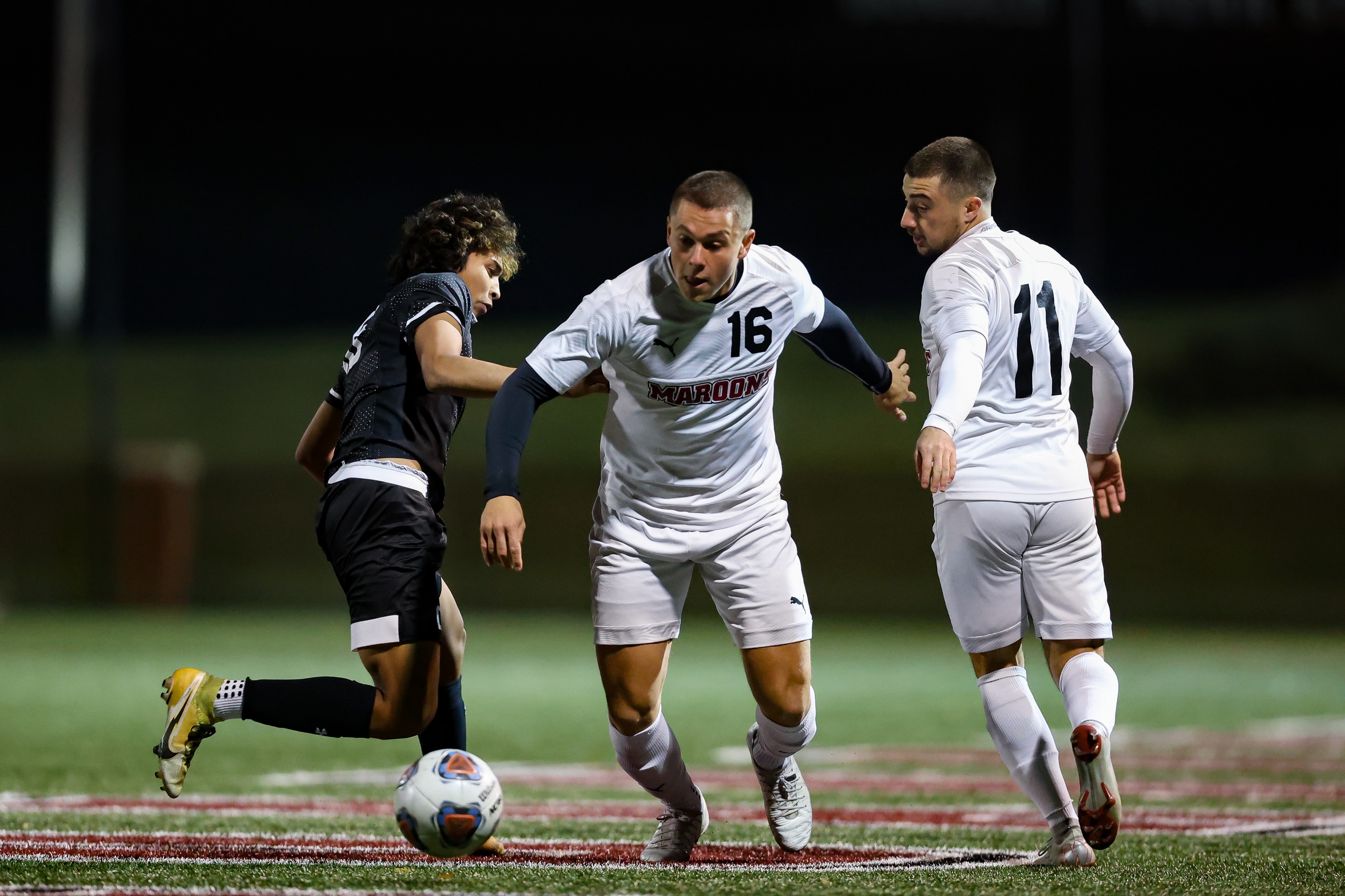 action photo of RC men's soccer player Chris Jerrild going past a defender
