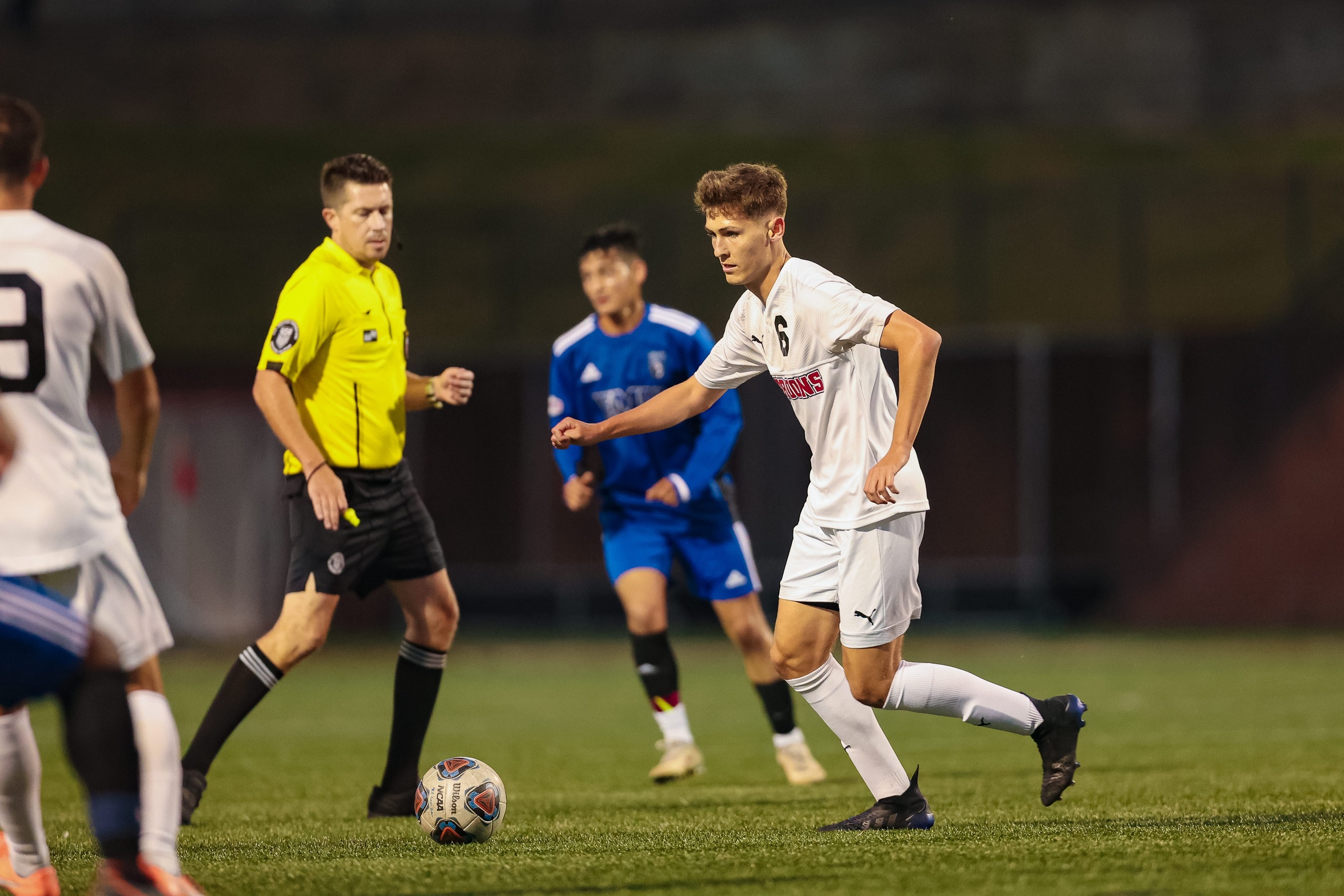 action photo of RC men's soccer player Dylan Berk preparing to kick