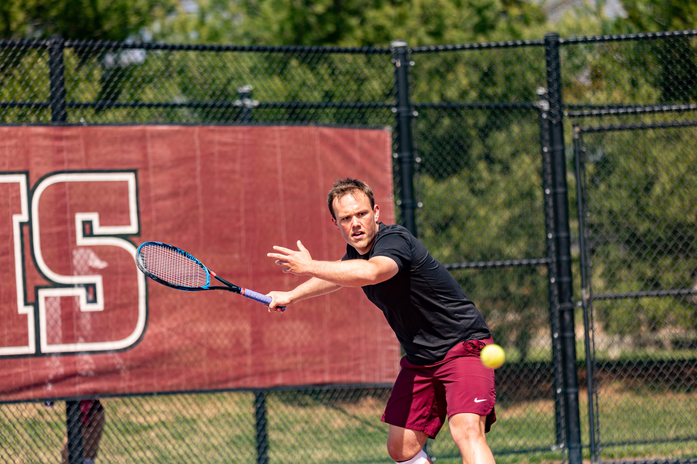 action photo of RC tennis player Jack Fishwick hitting a forehand