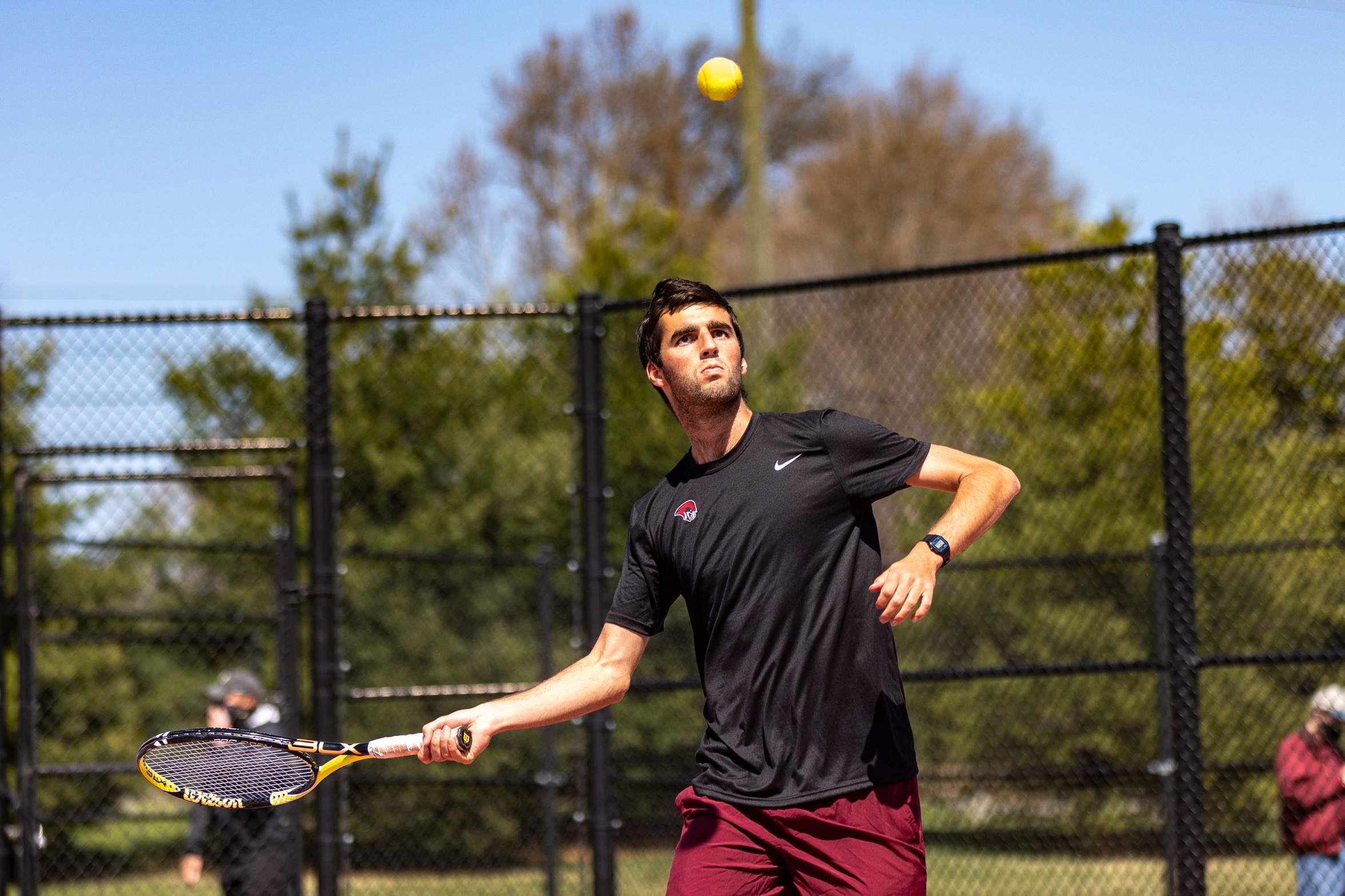 action photo of RC tennis player Zach Kriebel hitting a forehand