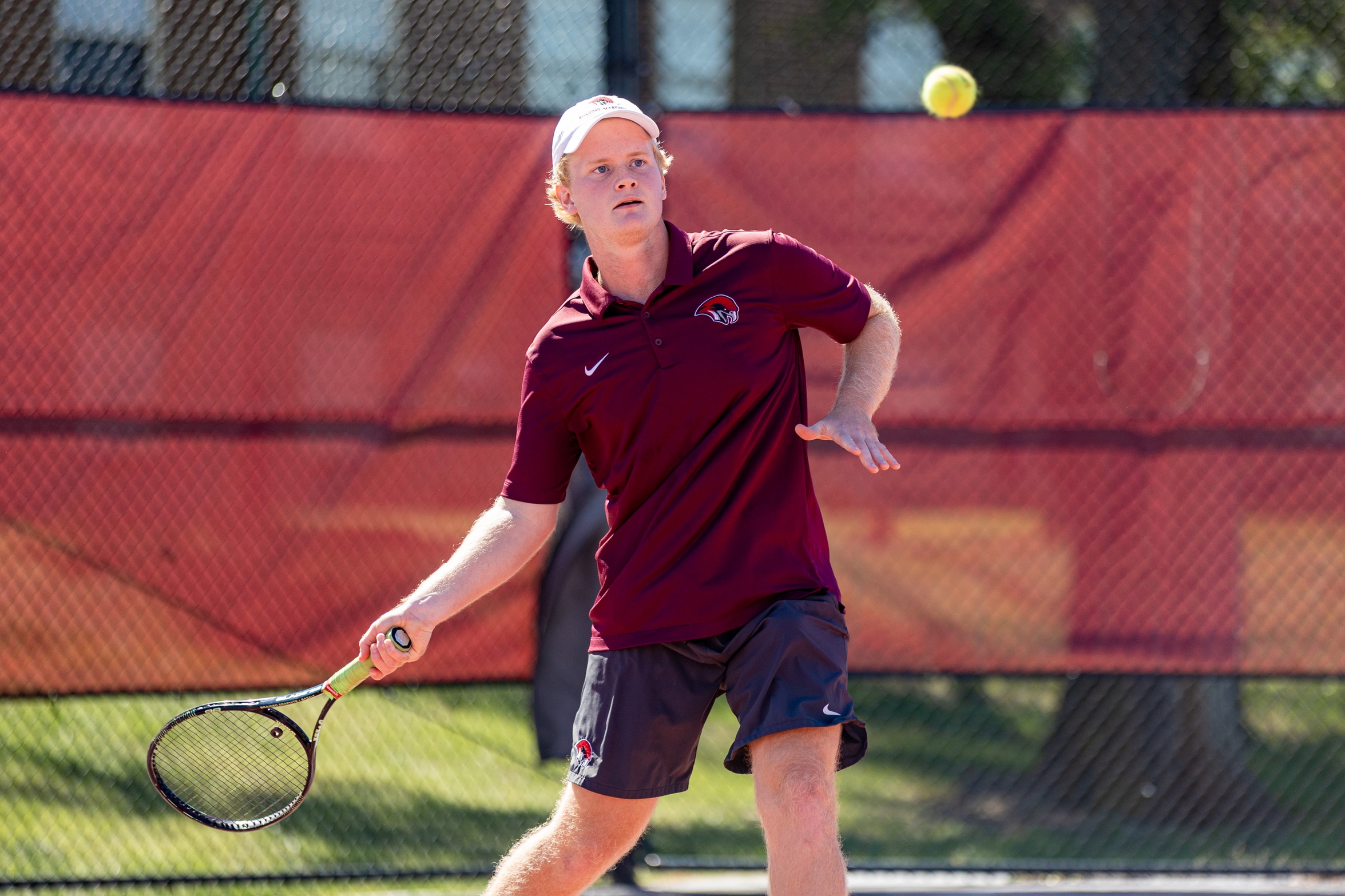 action photo of Roanoke men's tennis player Michael Morrell hitting a forehand