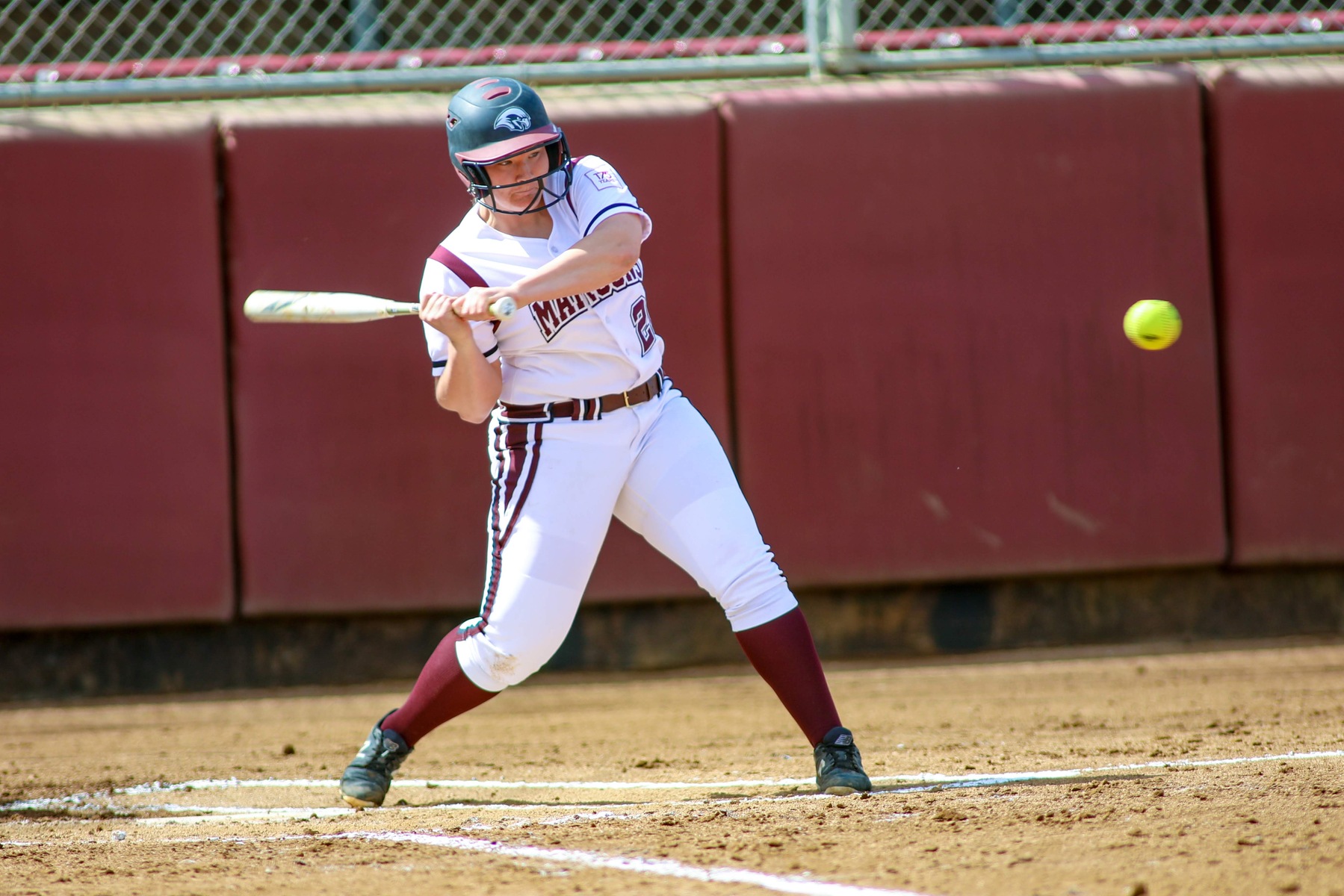 action photo of an RC softball player hitting the ball