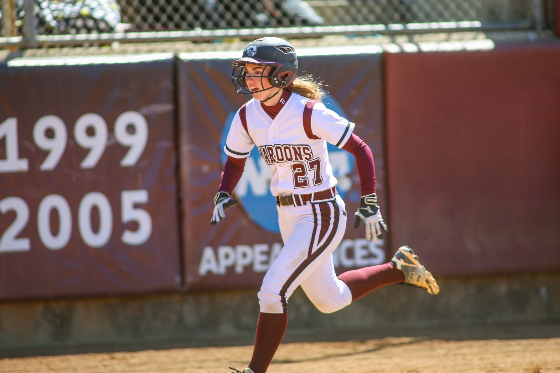 action photo of RC softball player Riley Croghan running home