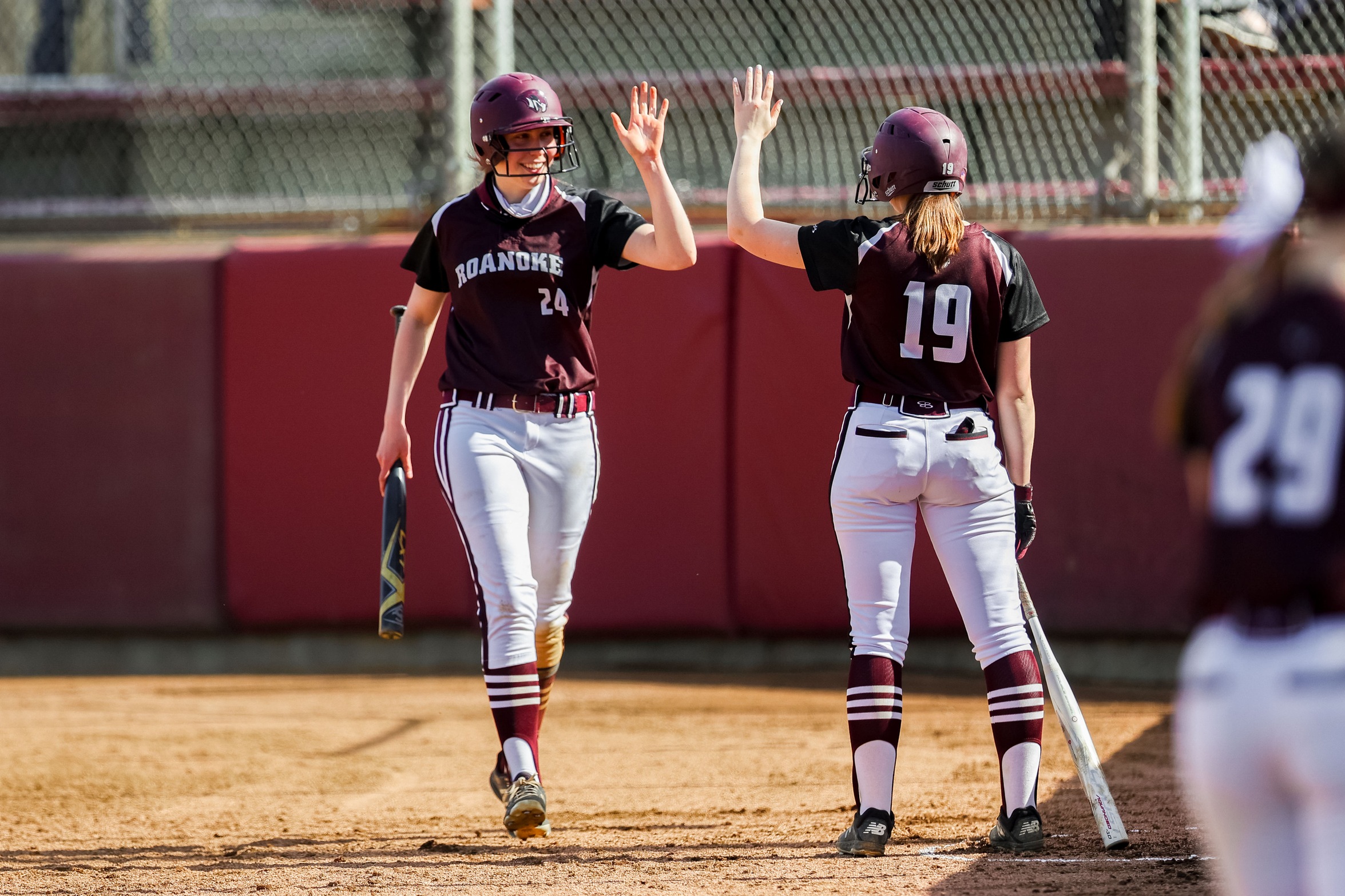 action photo of RC softball players Rebecca Hensley and Makayla Austin celebrating