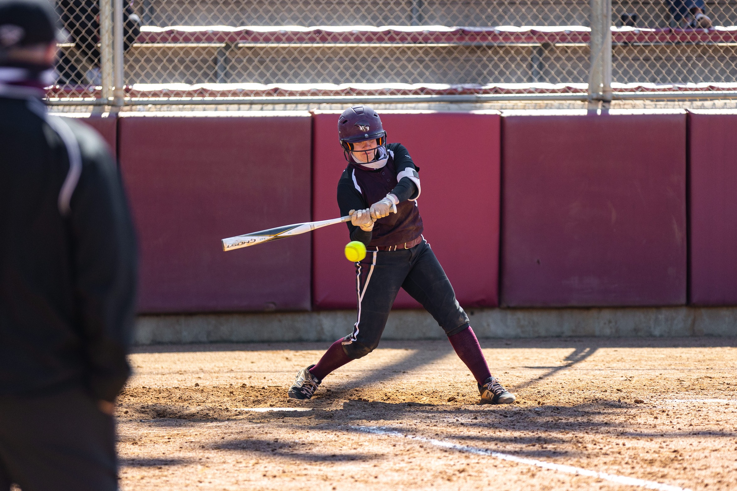 action photo of RC softball player hitting