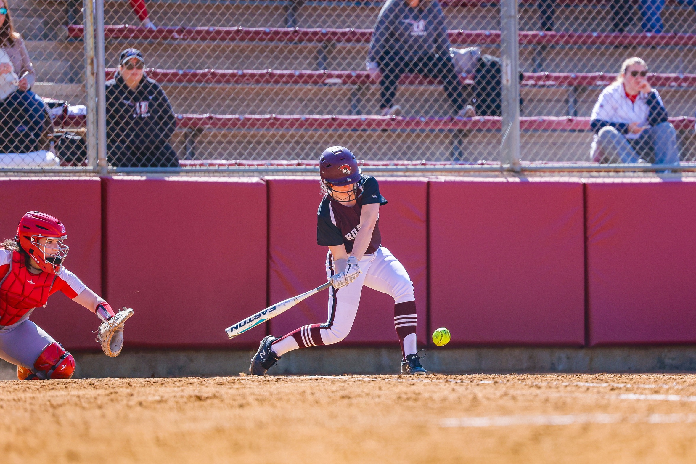 action photo of RC softball player hitting