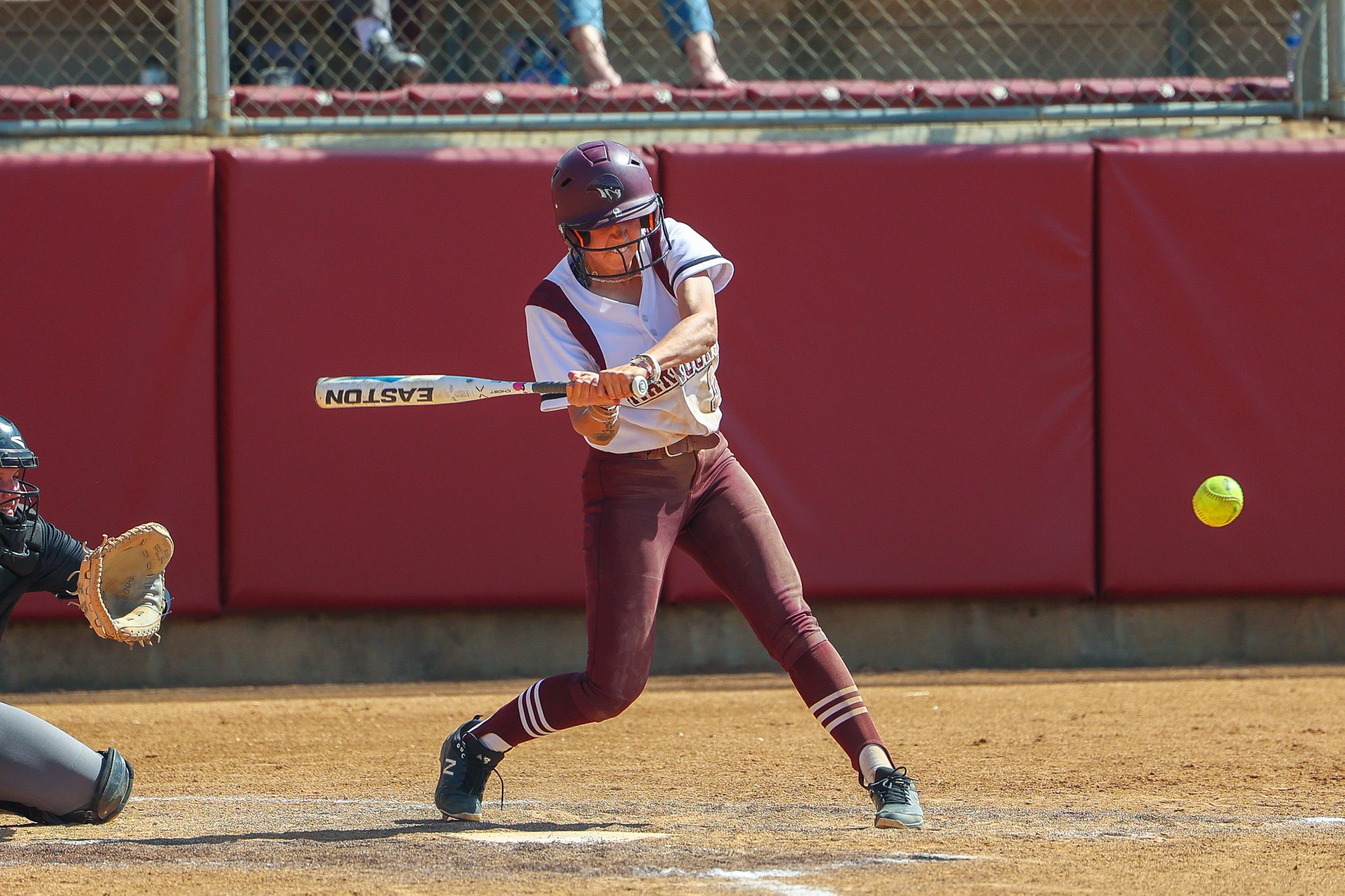 action photo of RC softball player hitting