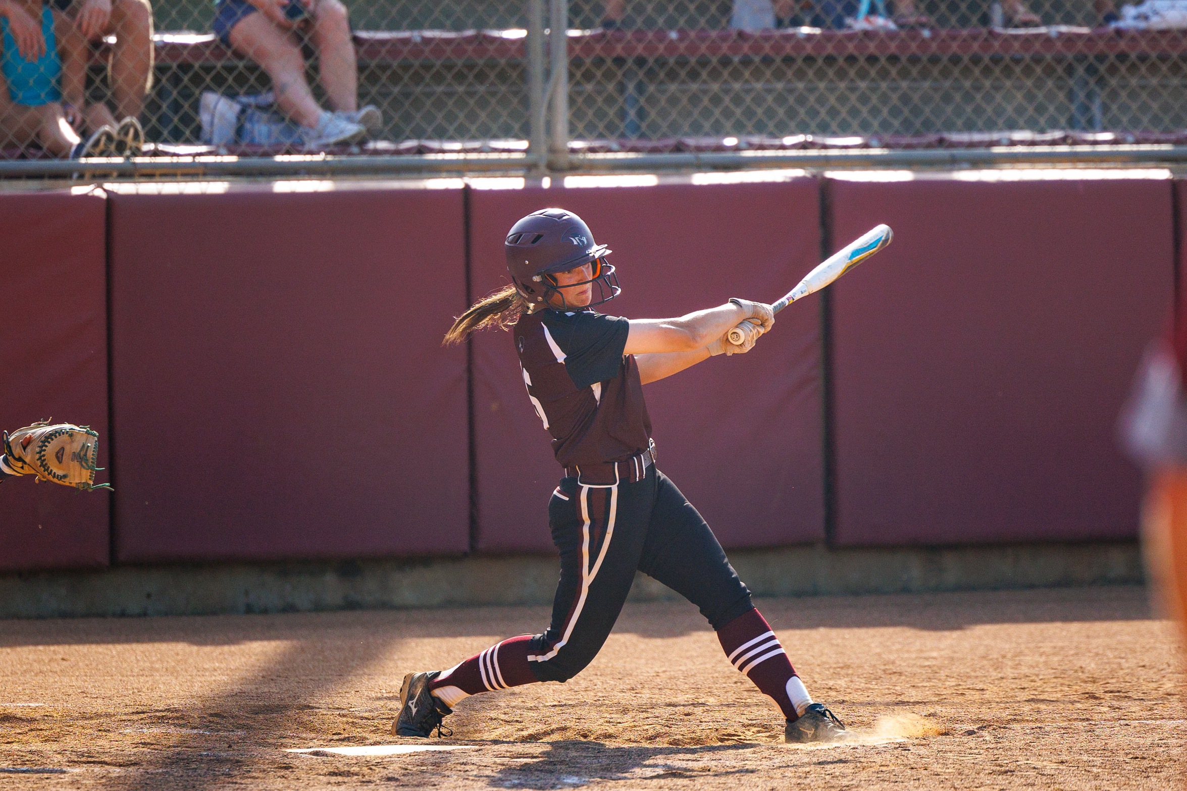 action phot of RC softball player Meri Bostic hitting