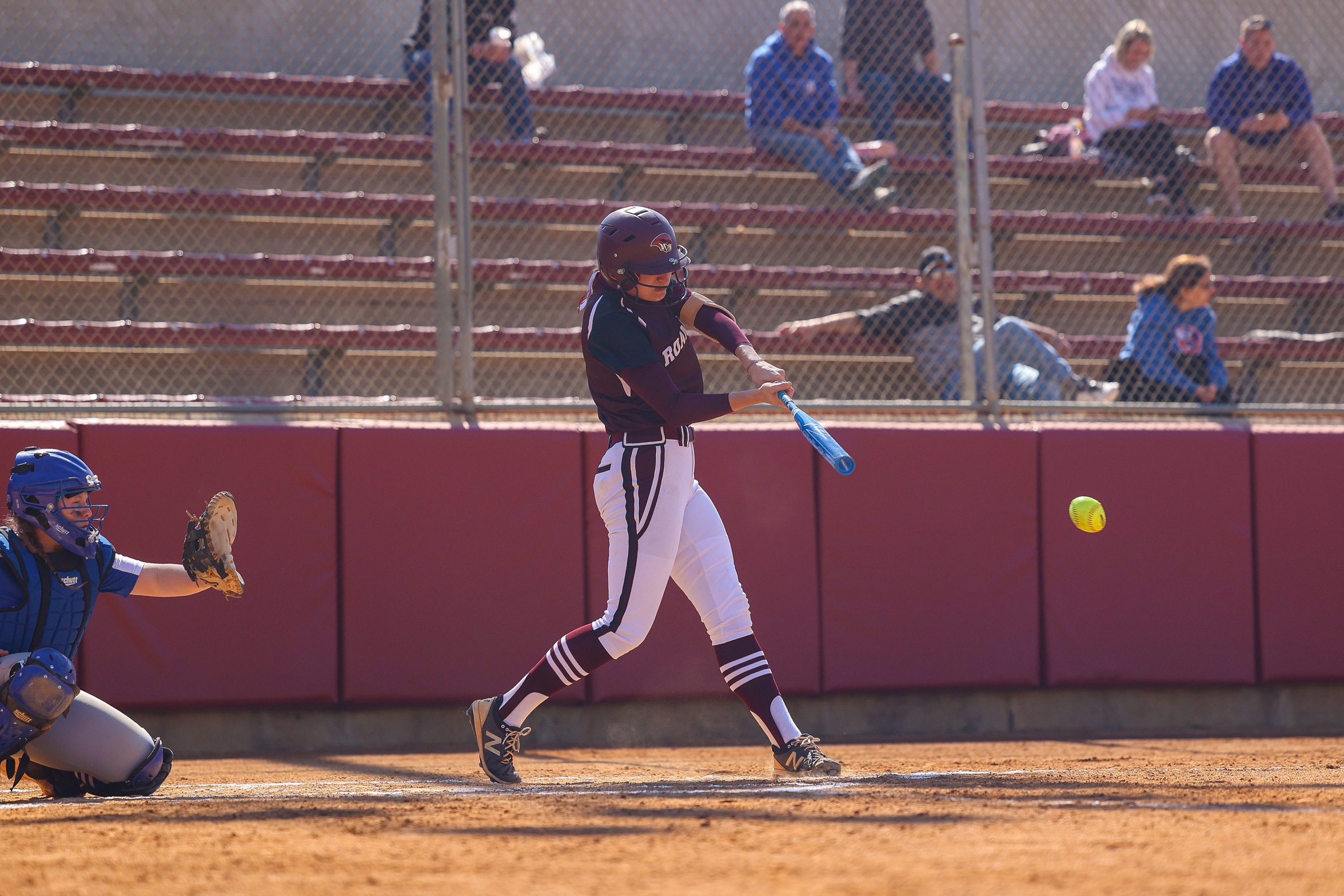 action photo of RC softball player hitting