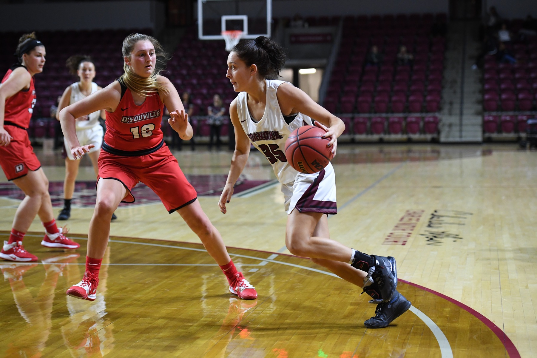 action photo of RC basketball player Corinne McPadden driving past a defender