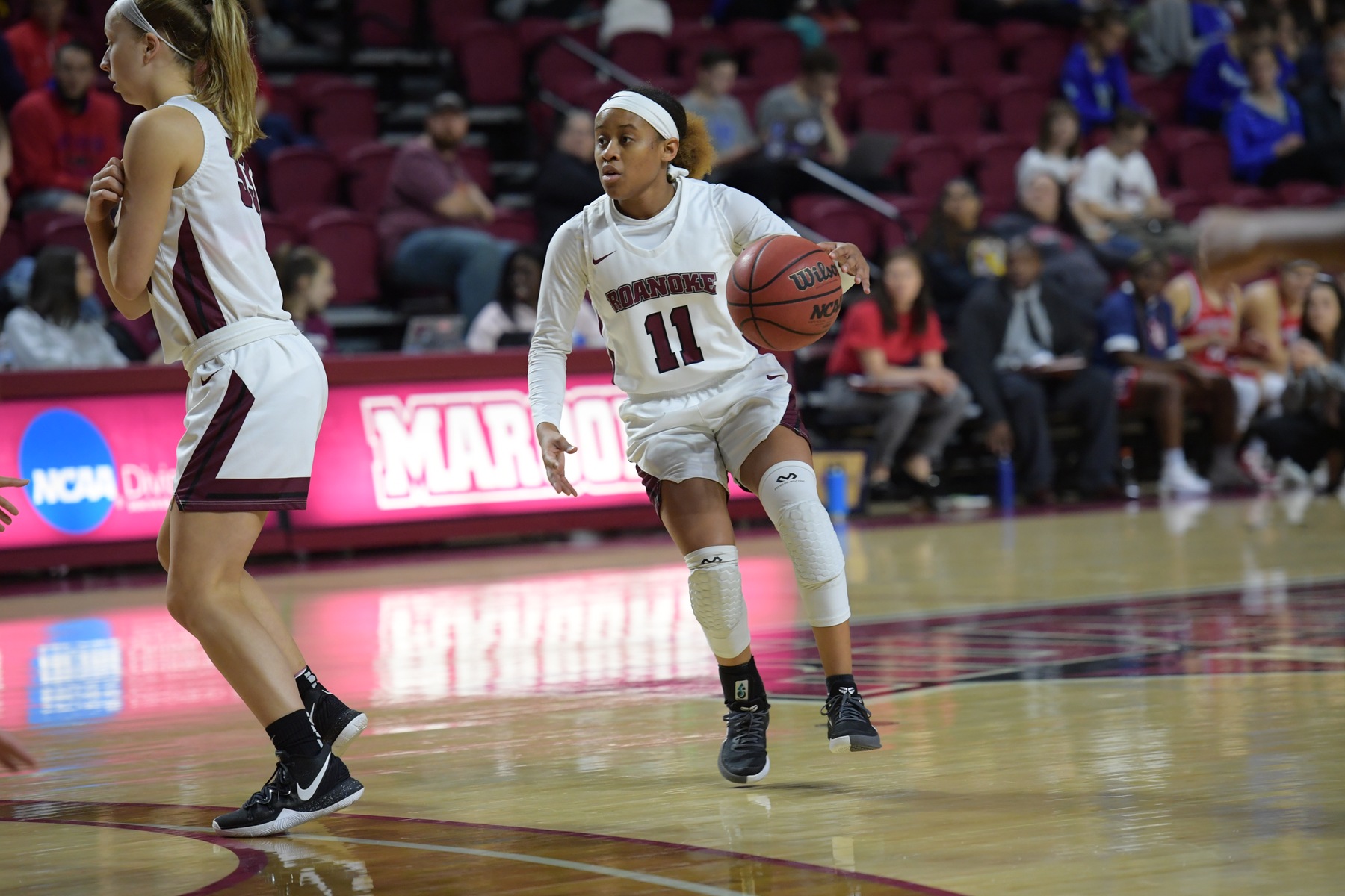 action photo of RC basketball player Whitney Hopson dribbling in the frontcourt