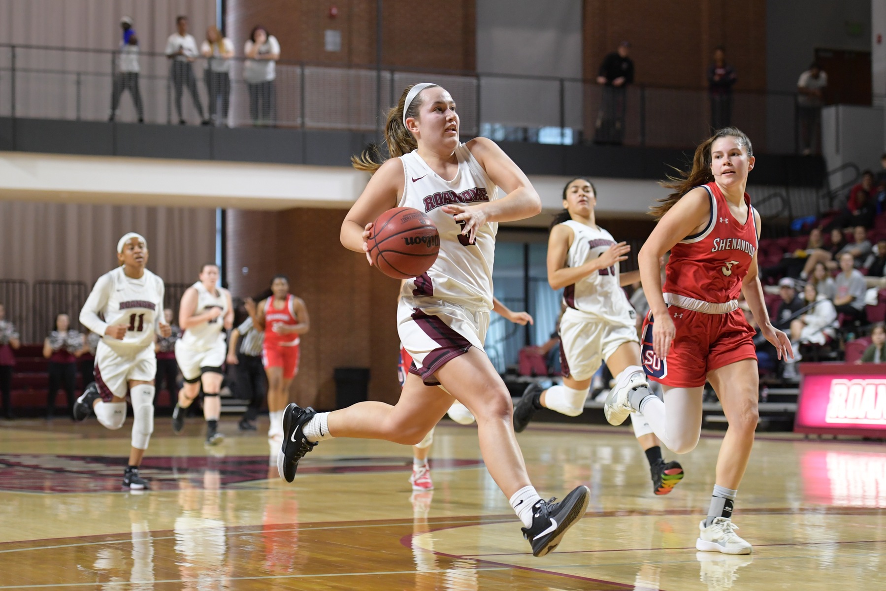 ACTION PHOTO OF rc WOMEN'S BASKETBALL PLAYER sAYRE bRANDSTATTER DRIVING TO THE HOOP