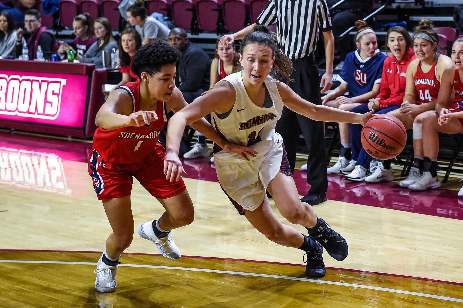 action photo of RC basketball player Kristina Harrel driving to the hoop