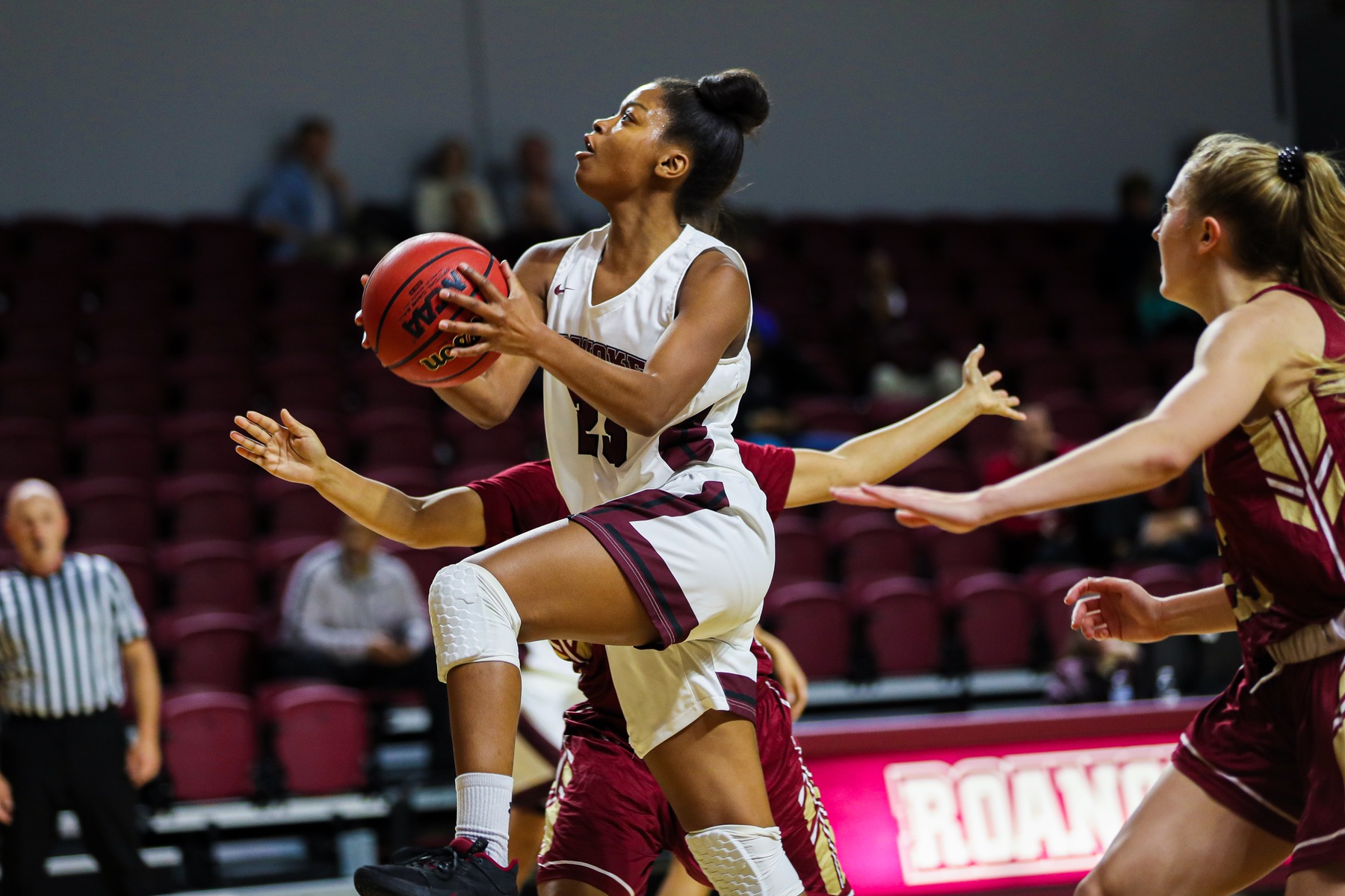 action photo of RC basketball player Ayanna Scarborough driving to the basket