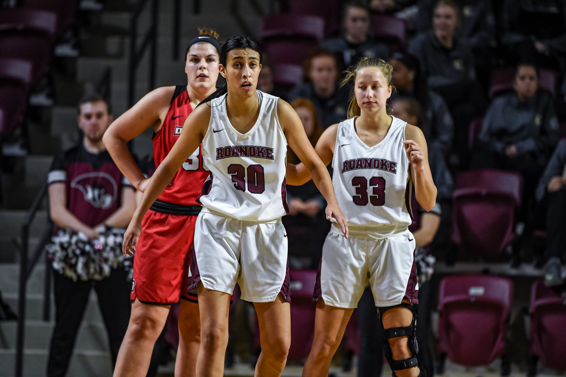 action photo of RC basketball player Renee Alquiza playing defense