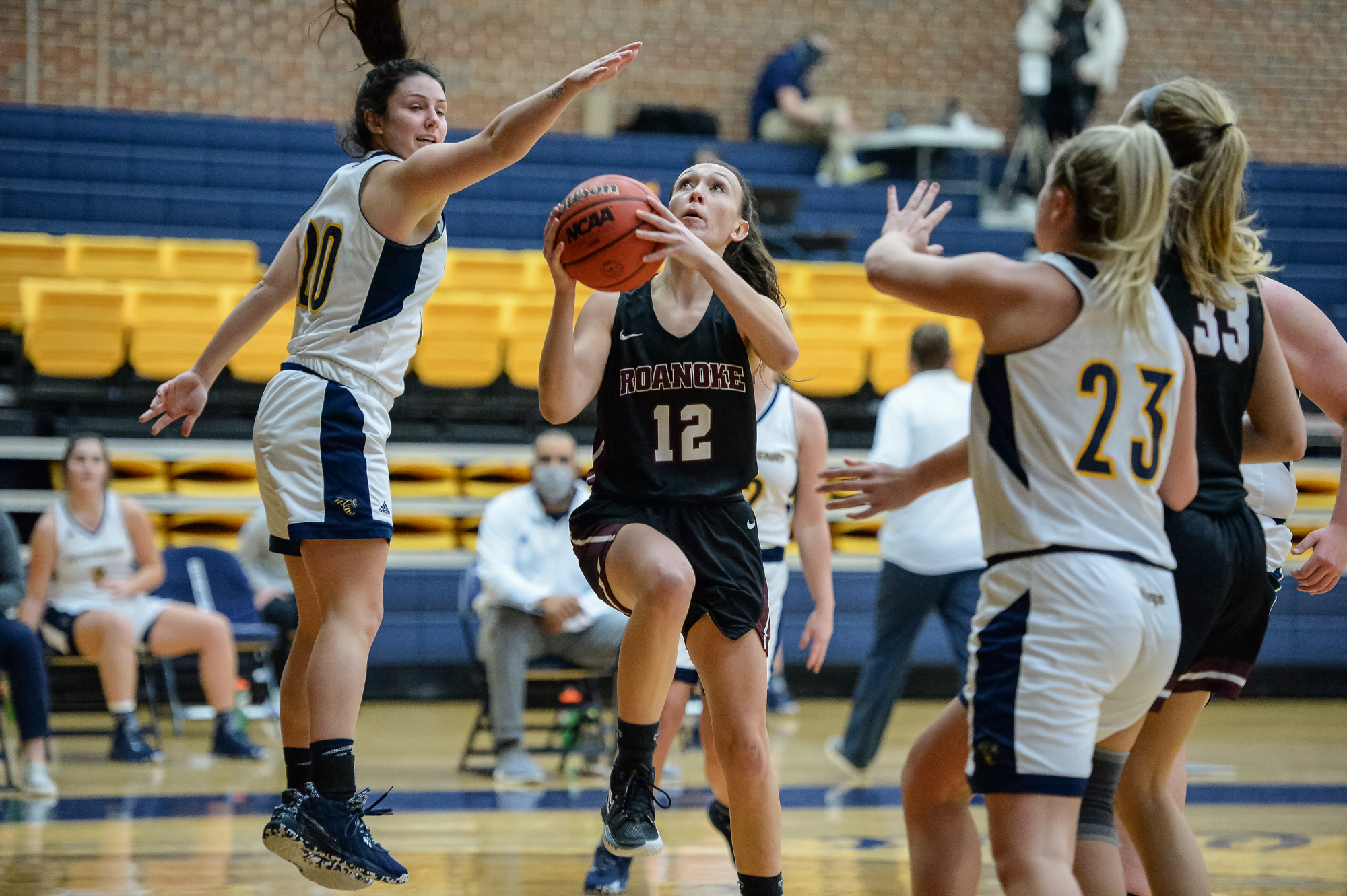 action photo of RC basketball player Kristina Harrel shooting