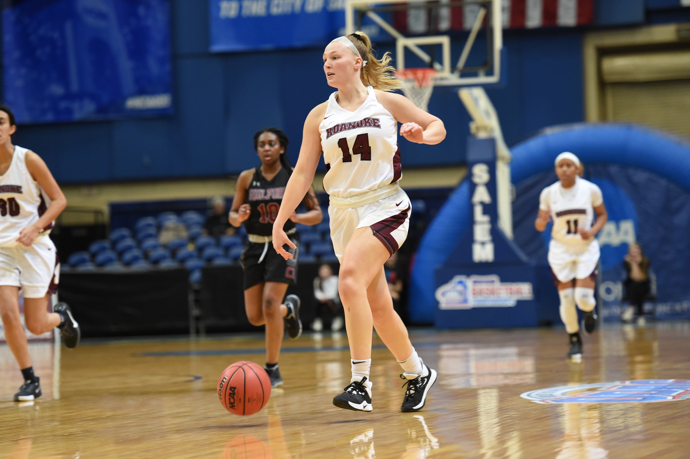 action photo of RC basketball player Morgan Micallef dribbling up the court